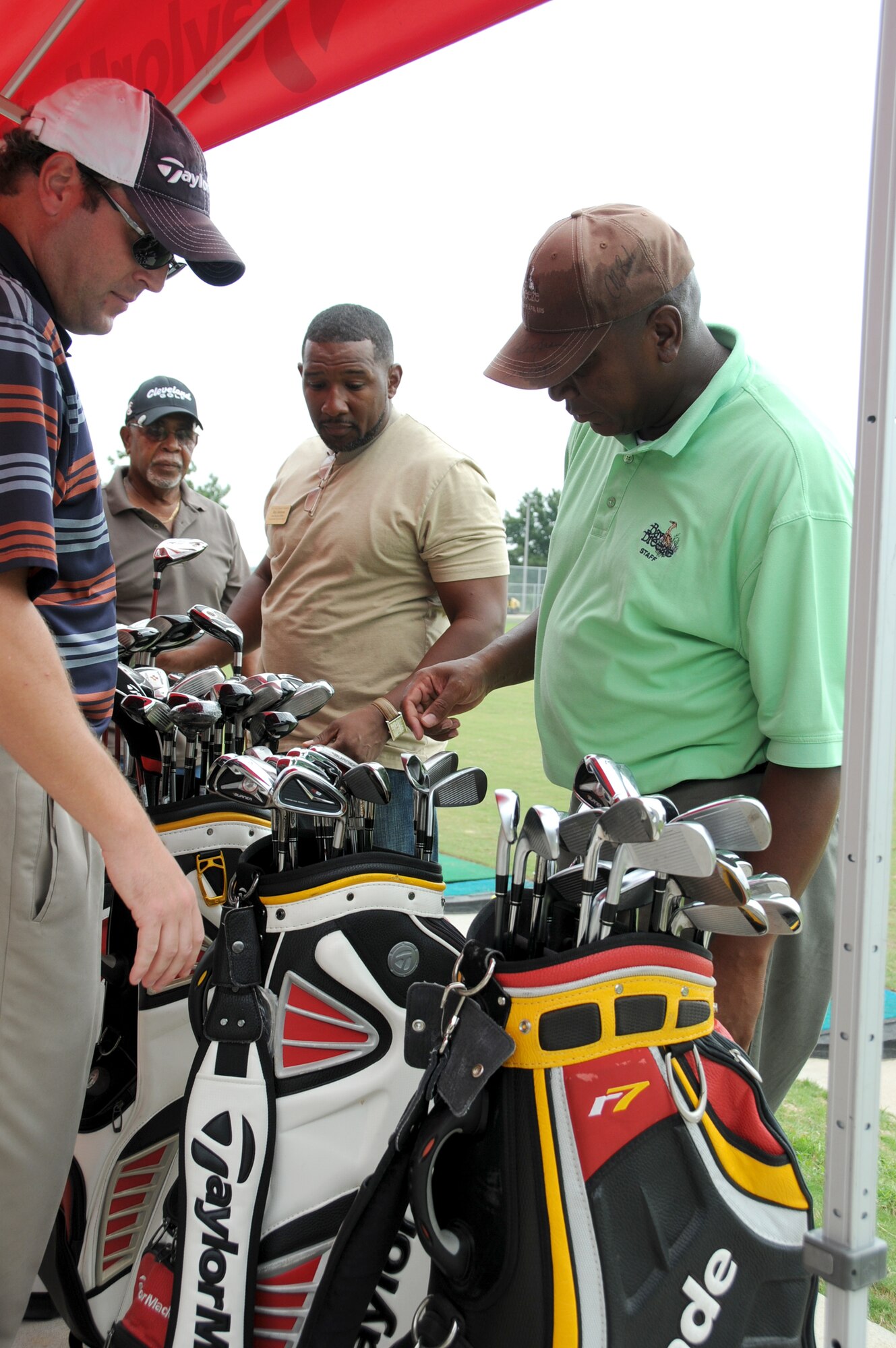 Taylor Made representative Mark Stratmann shows golf clubs and bags to Edward Williams, Roy Jackson and Edmon Harvey.  Mr. Williams is an Army retiree from Ocean Springs, Mr. Jackson works in the 81st Force Support Squadron and Mr. Harvey is a Navy retiree from Biloxi.  Bay Breeze reopened to golfers last month.  (U.S. Air Force photo by Kemberly Groue)