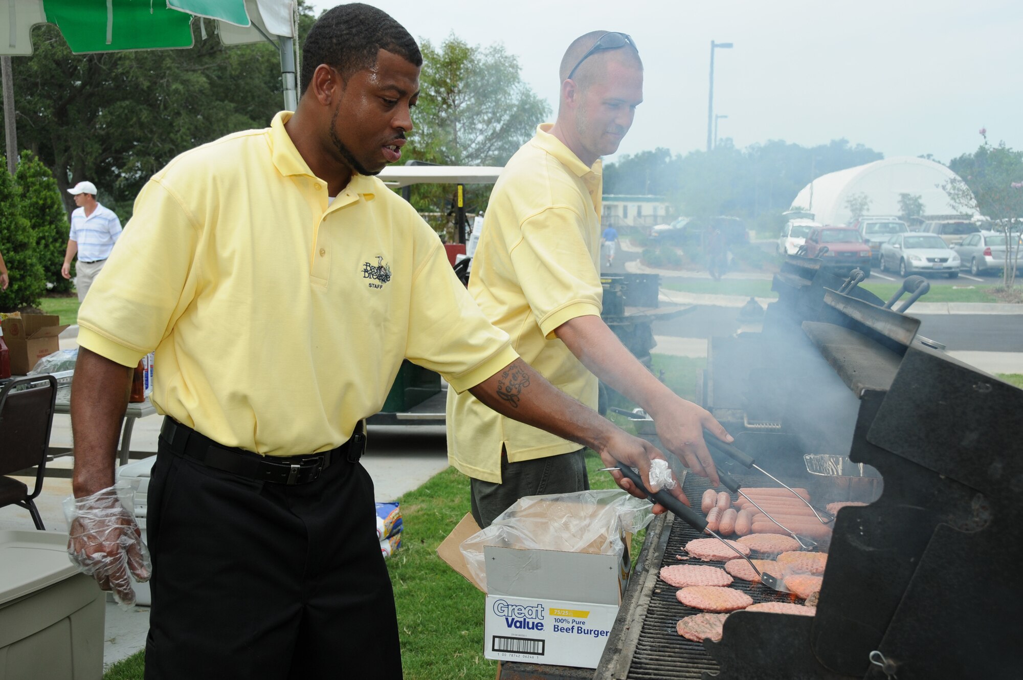 Marlon Brown, left, and Nick Curtis, Bay Breeze staff man the grill for the free lunch.  (U.S. Air Force photo by Kemberly Groue)