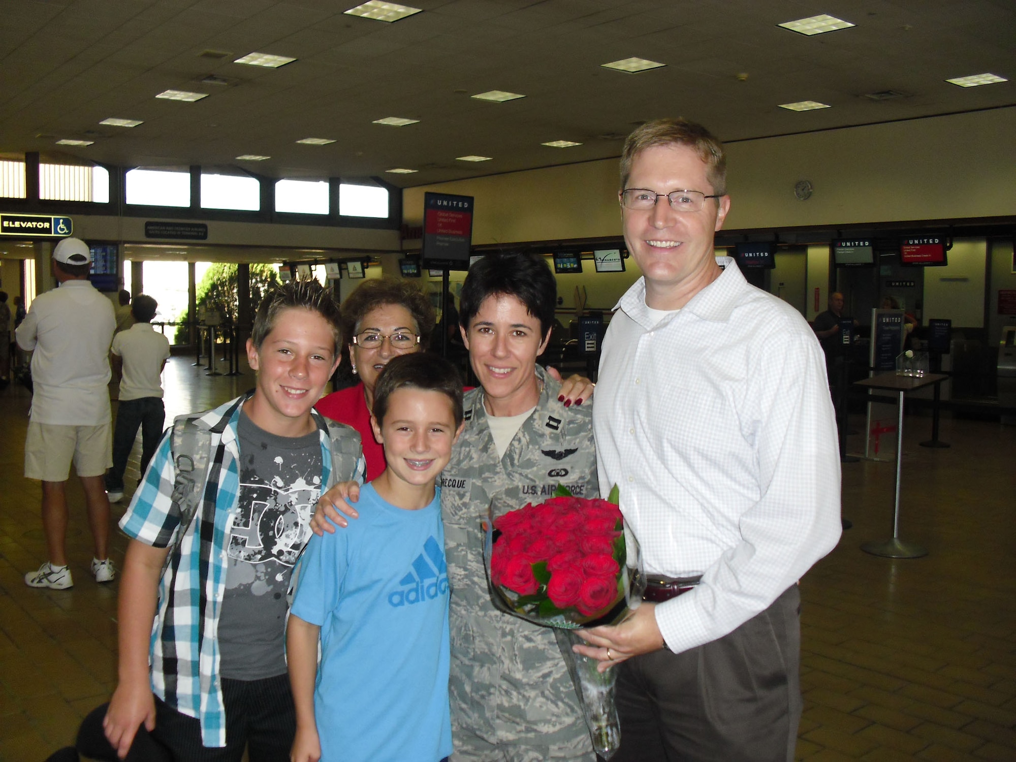 TRAVIS AIR FORCE BASE, Calif. -- Capt. Susan Labrecque, executive officer for the 349th Air Mobility Wing commander, is welcome home by her family a the Sacramento International Airport, Sacramento, Calif., Sept. 2. Col. Jay Flournoy, 349th Wing Commander and his wife were also there to welcome her back. (Courtesy photo/Mrs. Flournoy)

