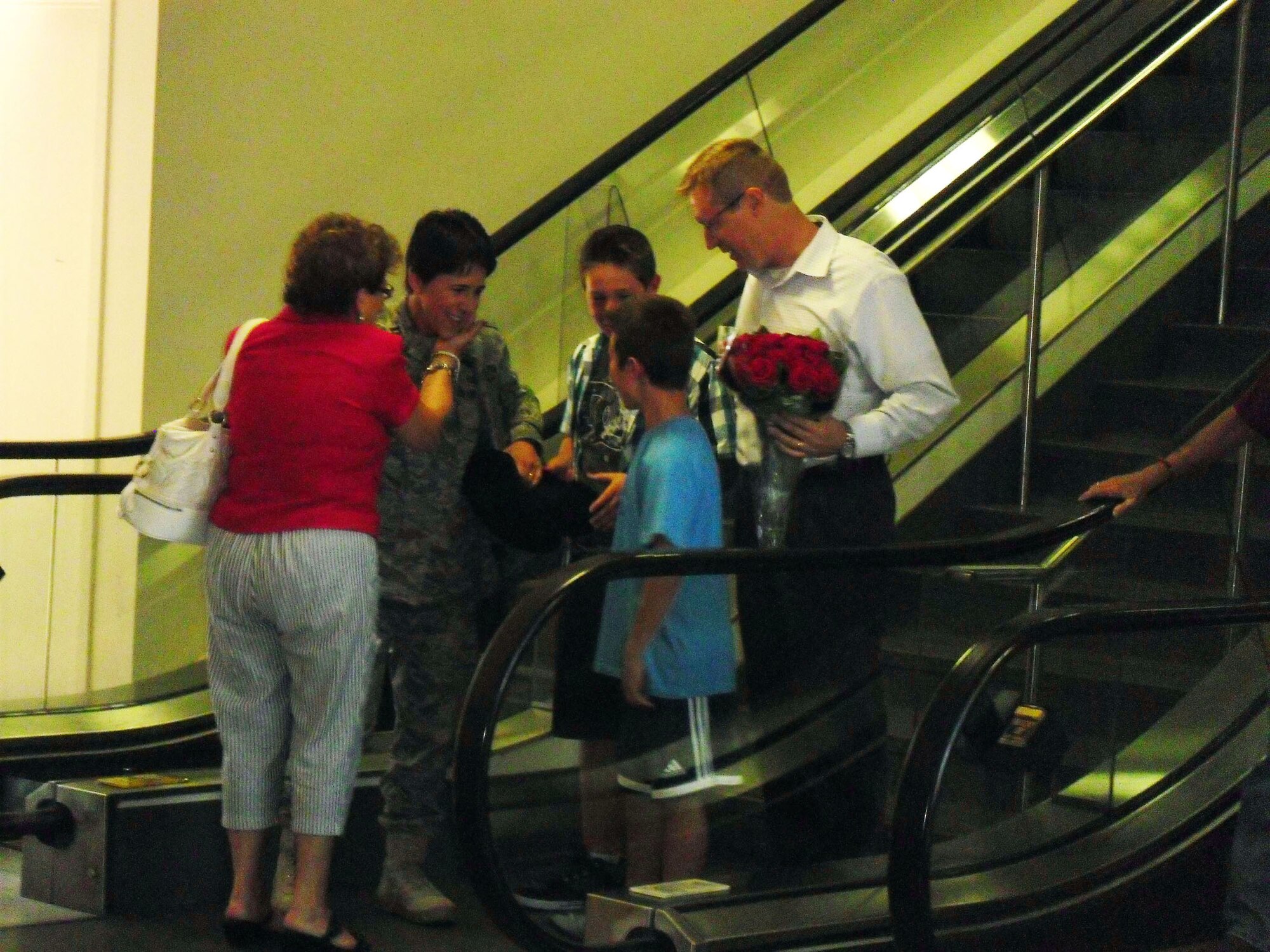 TRAVIS AIR FORCE BASE, Calif. -- Capt. Susan Labrecque, executive officer for the 349th Air Mobility Wing commander, is welcome home by her family a the Sacramento International Airport, Sacramento, Calif., Sept. 2. Col. Jay Flournoy, 349th Wing Commander and his wife were also there to welcome her back. (Courtesy photo/Mrs. Flournoy)

