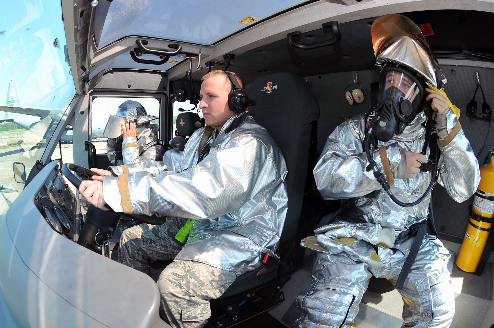 (Left to right) Staff Sgt. Benjamen Morin, Airman 1st Class Justin Fellure and Airman 1st Class Derek Jose, 19th Civil Engineer Squadron firefighters, “gear up” Aug. 24 to respond to a simulated aircraft fire. The fire suits can handle heat ranging from 1,200 to 1,500 degrees Fahrenheit. (U.S. Air Force photo by Staff Sgt. Chris Willis)