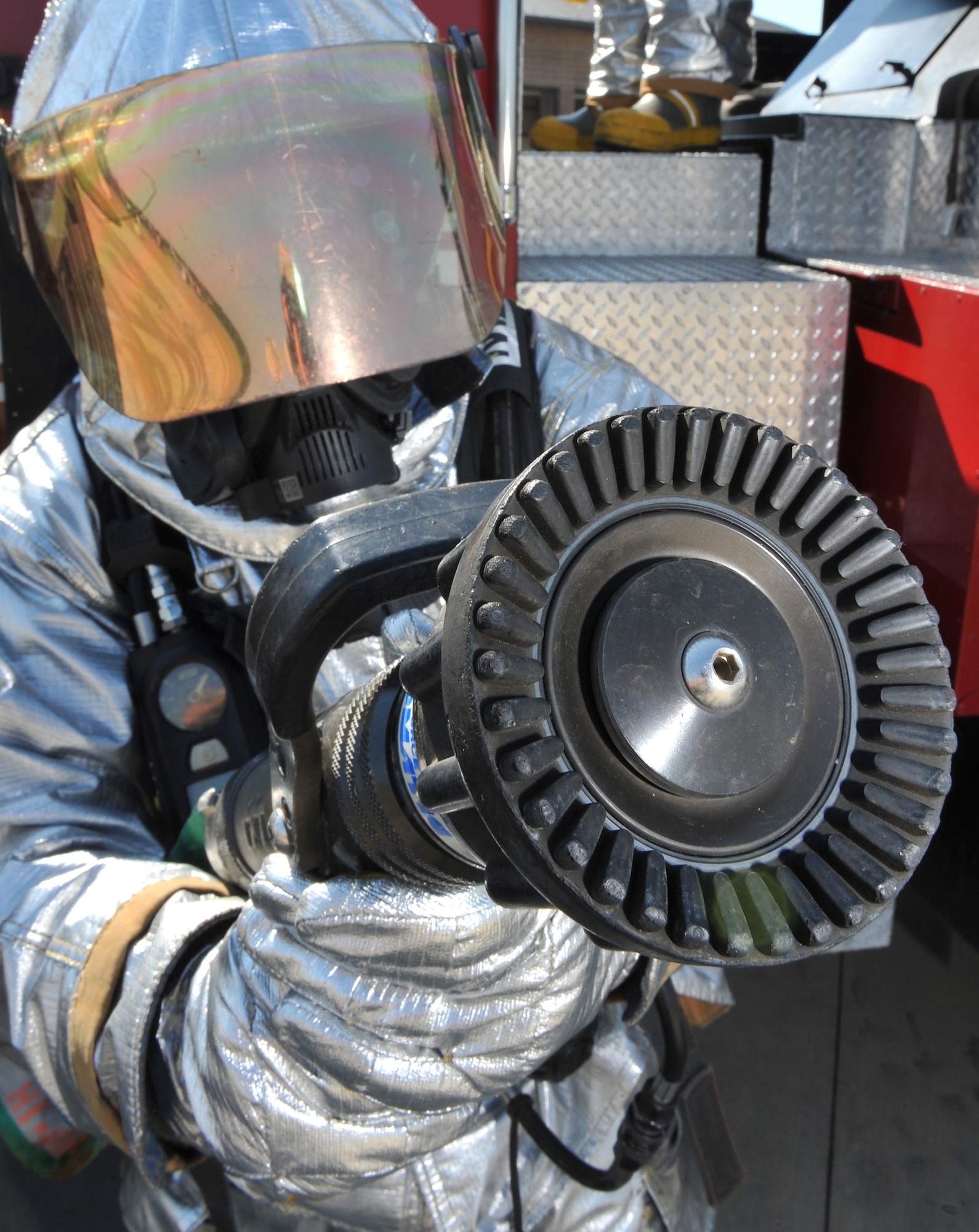 Airman 1st Class Justin Fellure, 19th Civil Engineer Squadron firefighter, aims an attack line Aug. 24. The fire department prides itself on having one of the highest training programs in the Air Force. Two members received 100 percent on their Career Development Courses. They upgraded 13 members to their 5-level with a CDC average of 94 percent. (U.S. Air Force photo by Staff Sgt. Chris Willis)