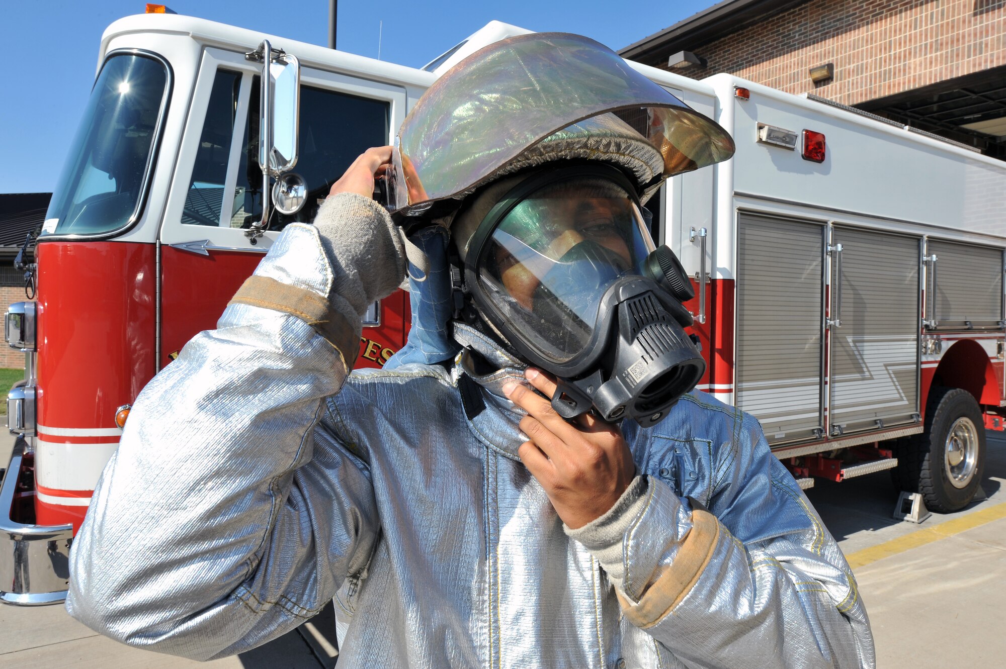 Airman 1st Class Rodney Welch, 19th Civil Engineer Squadron firefighter, puts his helmet on Aug. 24 during a simulated fire response. The fire department answered 60 emergency calls last month and 686 in 2009. (U.S. Air Force photo by Staff Sgt. Chris Willis)