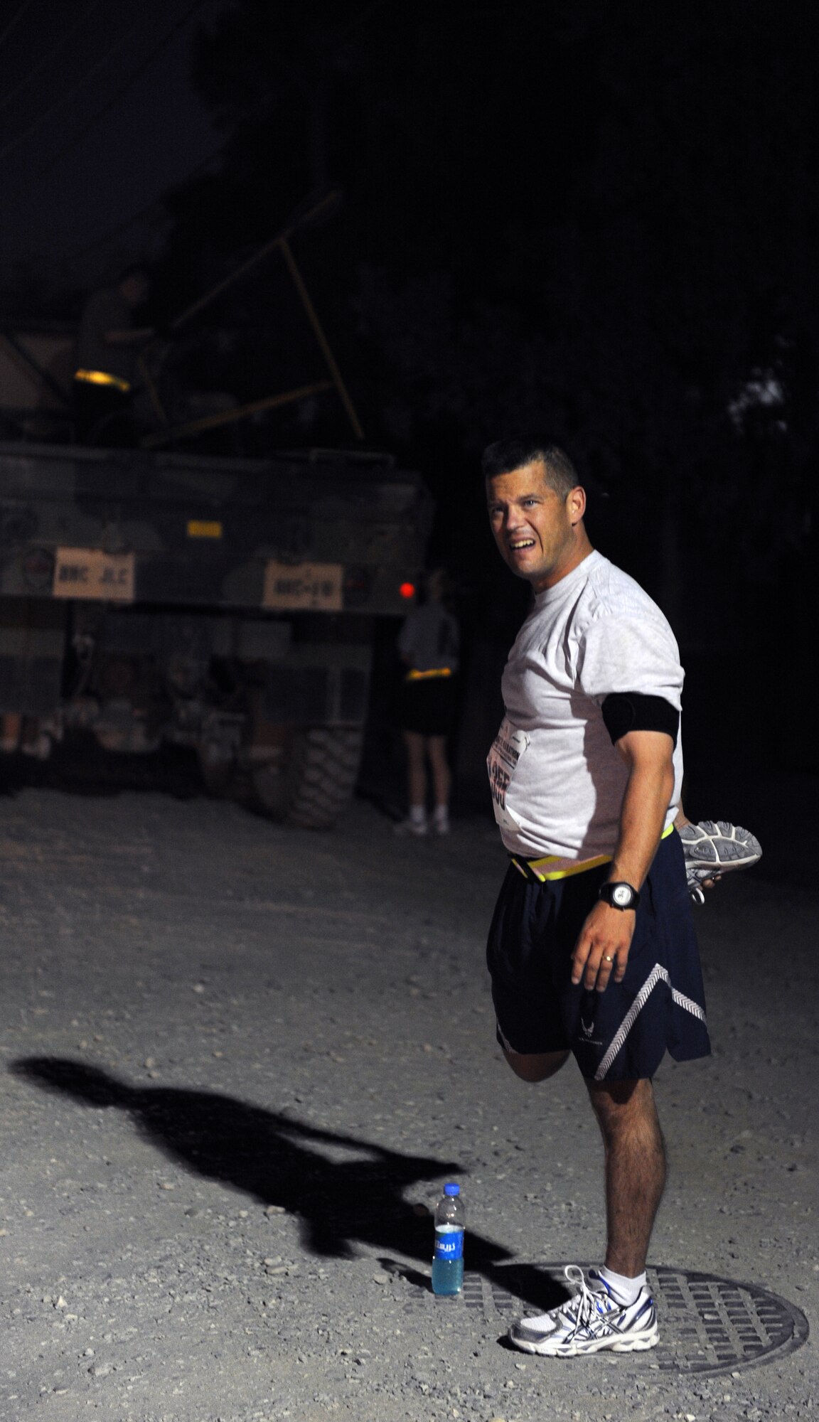 Air Force Lt. Col. Bob Noonan, the commander of the 817th Expeditionary Air Support Operations Squadron, stretches before running in the Air Force-sponsored Half Marathon Sept. 4, 2010 at Bagram Airfield, Afghanistan. More than 1,000 members of Team Bagram ran in the event.