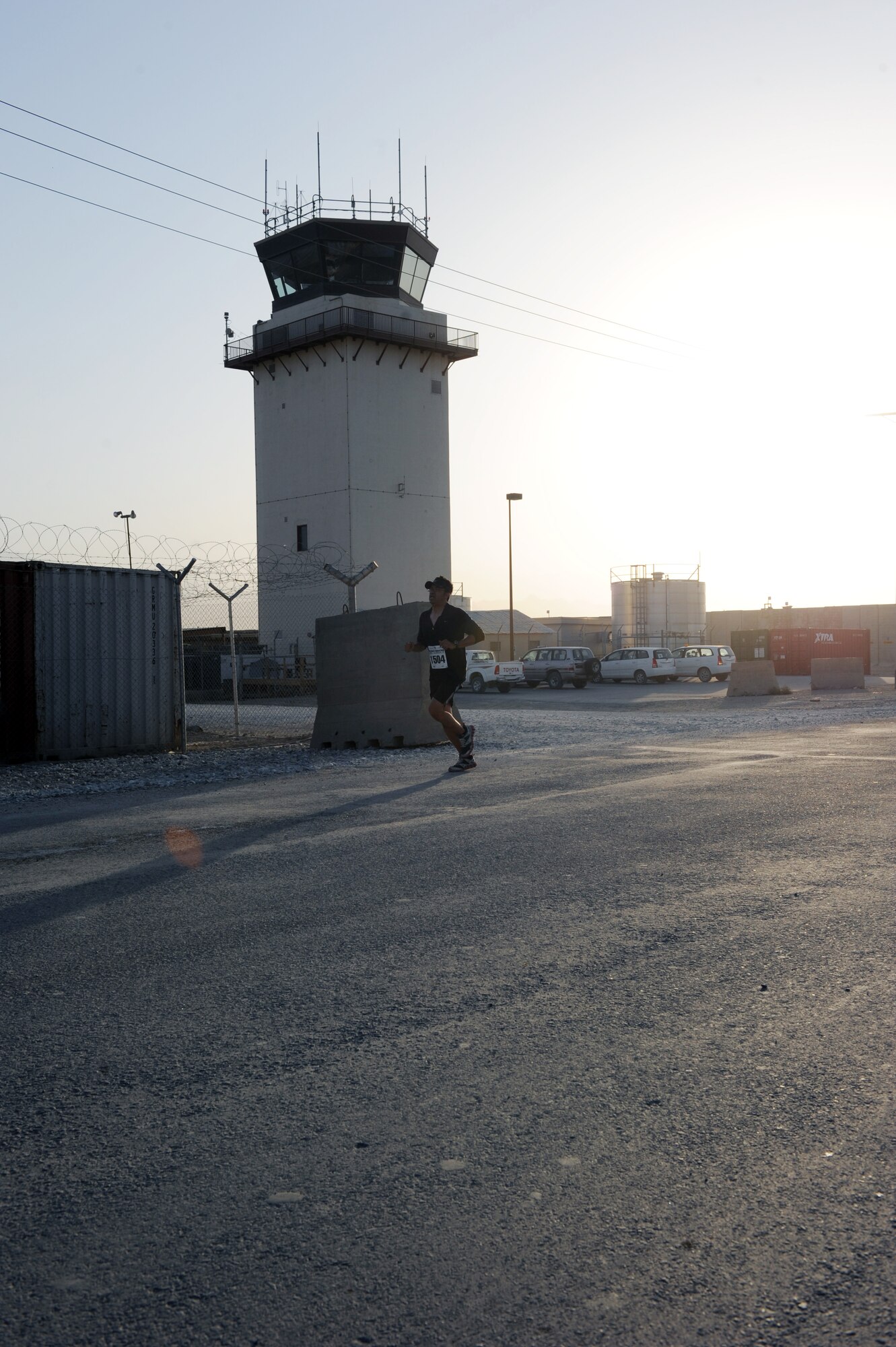 A participant runs by the air traffic control tower during the Air Force-sponsored Half Marathon Sept. 4, 2010 at Bagram Airfield, Afghanistan. More than 1,000 members of Team Bagram ran in the event.