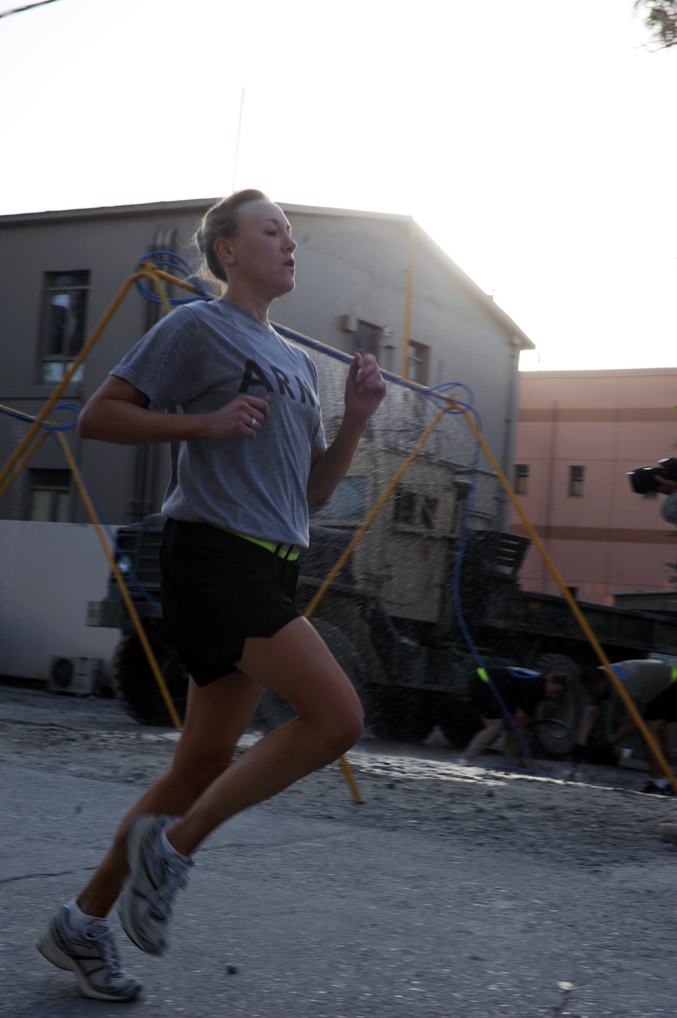 U.S. Army Capt. Ronee Farrell, a medic, sprints to the finish with the fastest female time in the Air Force-sponsored Half Marathon Sept. 4, 2010 at Bagram Airfield, Afghanistan. The captain completed the 13.1-mile circuit in 1:37:03. More than 1,000 members of Team Bagram ran in the event.