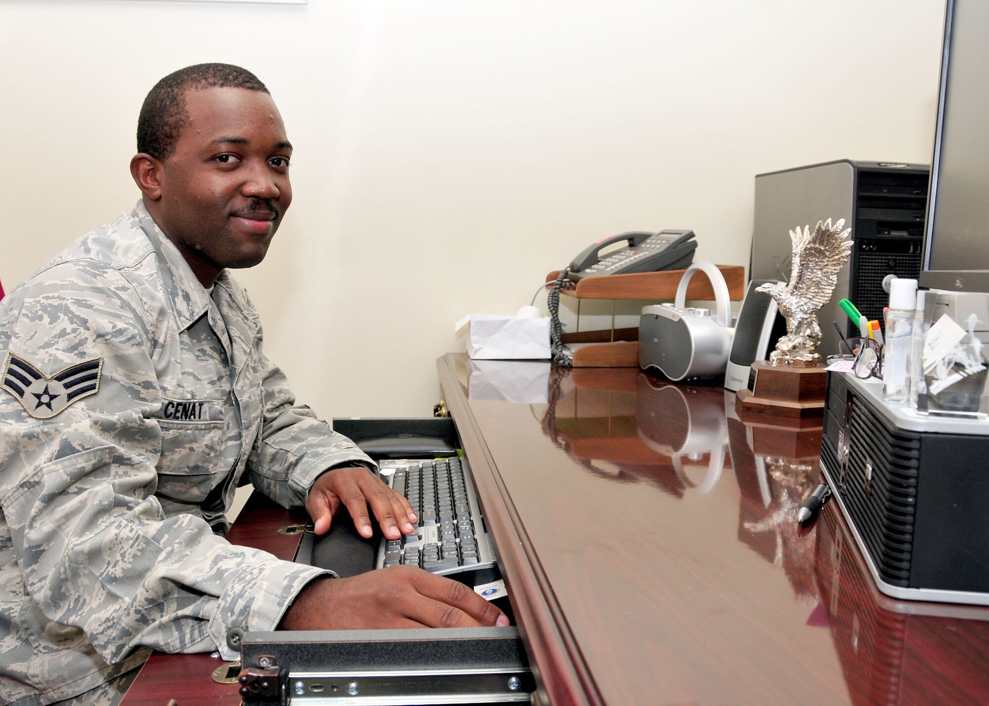ALTUS AIR FORCE BASE, Okla. -- Senior Airman Jean Cenat, document control specialist 97th Logistics Readiness Squadron, with his silver eagle trophy awarded for winning the Personal Body Challenge at Altus AFB. (U.S. Air Force photo by Tech. Sgt. Jennifer D. Seidl / Released 97th Air Mobility Wing Public Affairs)