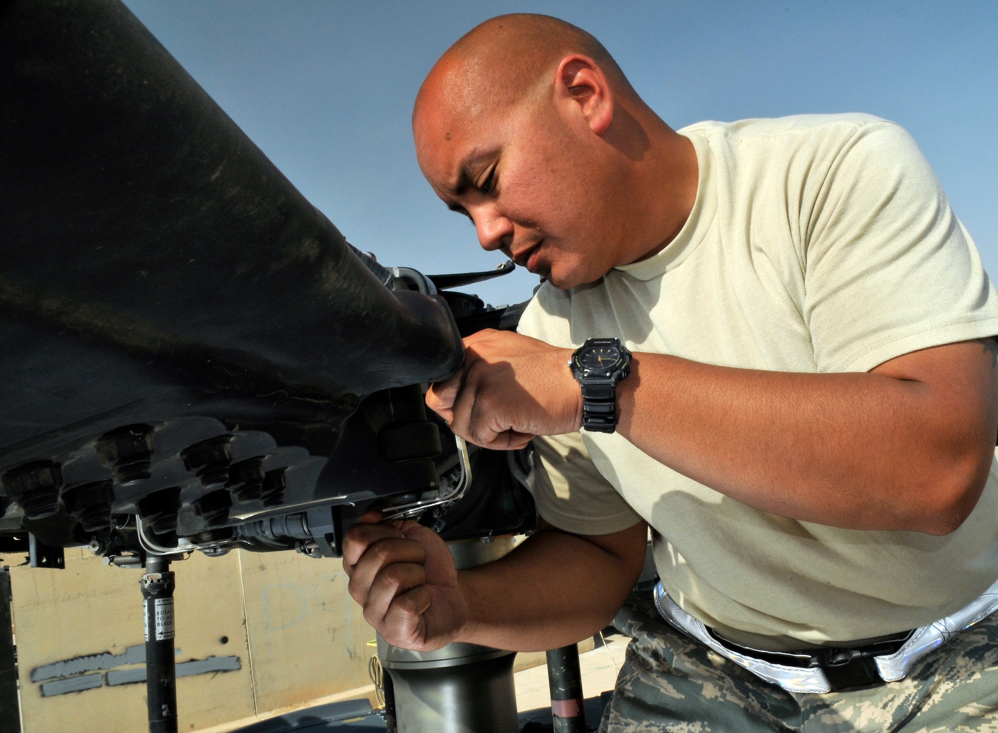 Staff Sgt. Joseph San Agustin, 64th Expeditionary Helicopter Maintenance Unit hydraulics specialist, inspects the main-rotor solid pins that hold the rotor blades to the main rotor Sept. 7, 2010, Joint Base Balad, Iraq. The HH-60 Pave Hawk Helicopter’s main rotor is 53 feet in diameter and spins at 258 revolution per minute. Sergeant San Augustin is a native of Guam and is deployed from Nellis Air Force Base, Nev. (U.S. Air Force photo/Staff Sgt. Phillip Butterfield)