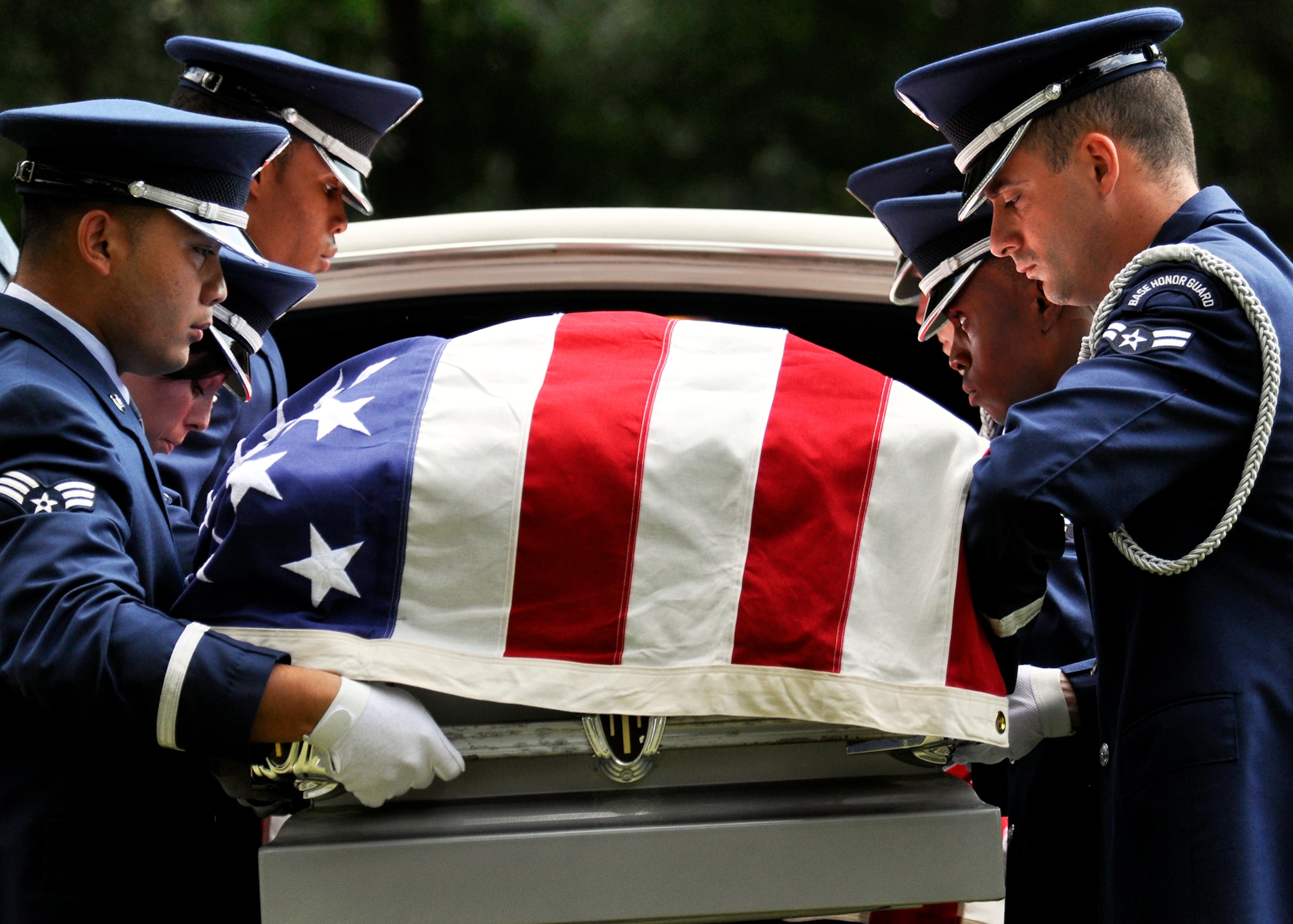 Members of the Eglin honor guard remove the flag-draped casket from the hearse during a mock funeral as part of the Eglin honor guard graduation Sept. 3.  The class performs a funeral ceremony with full honors for base leadership before graduating afterward.  The ceremony has four honor guard functions to be performed:  the flag detail, the 21-gun salute, pall bearers and bugler.  Eglin’s honor guard holds four classes per year with 15 Airmen graduating this particular class.  (U.S. Air Force photo/Samuel King Jr.)