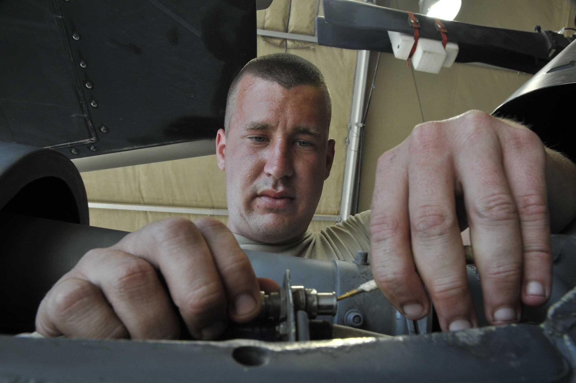 Senior Airman Kenneth Strube, 64th Expeditionary Helicopter Maintenance Unit electronic warfare systems journeyman, repins an EWS wire into its bulkhead connector Sept. 3, 2010, Joint Base Balad, Iraq. Like most military aircraft, the HH-60 Pave Hawk helicopter uses a mixture of offensive and defensive weapons. Airman Strube is a native of Gainesville, Fla., deployed from Moody Air Force Base, Ga. (U.S. Air Force photo/Staff Sgt. Phillip Butterfield)