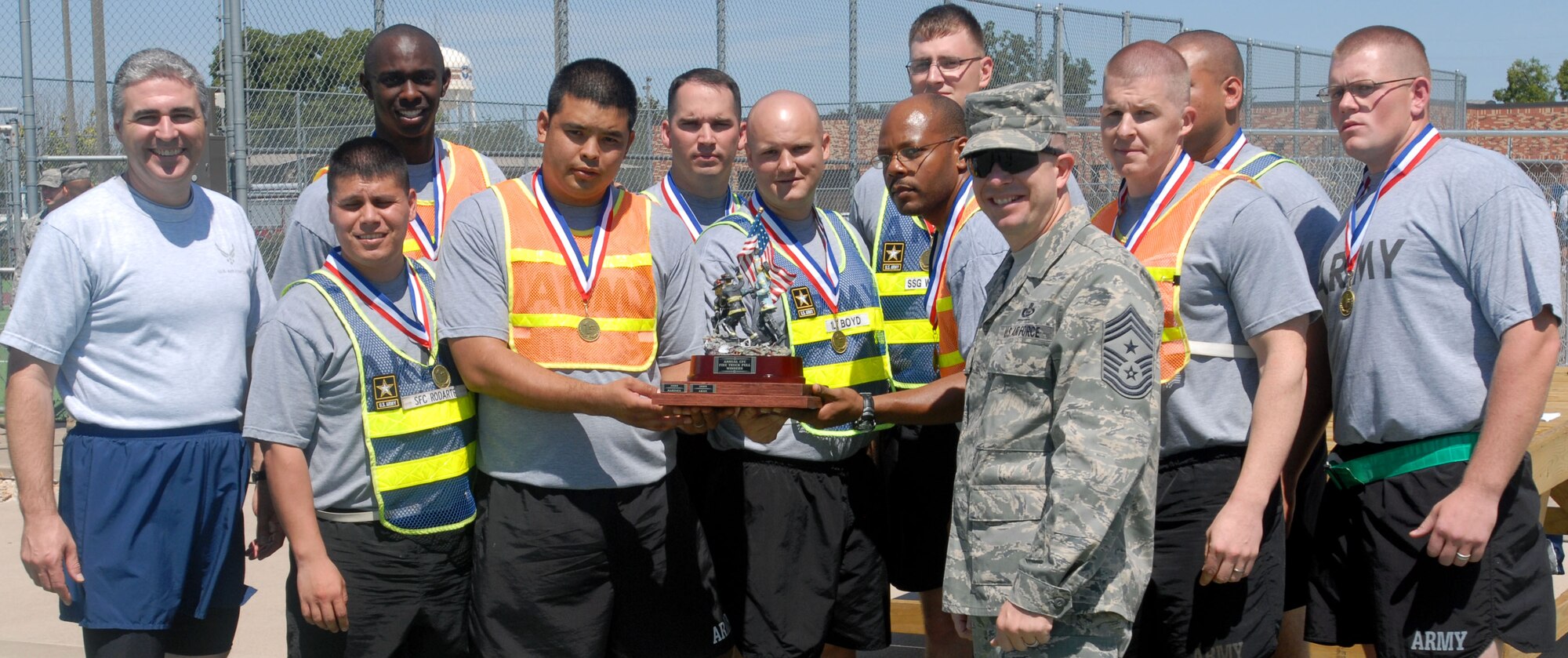 Col. Thomas Geary, 17th Training Wing Commander and Chief Criswell, 17th Training Wing Command Chief, present a trophy to the winners of the 1.5 mile relay race during Sports Day here Sept. 3. (U.S. Air Force photo/ Airman 1st Class Jessica D. Keith) 