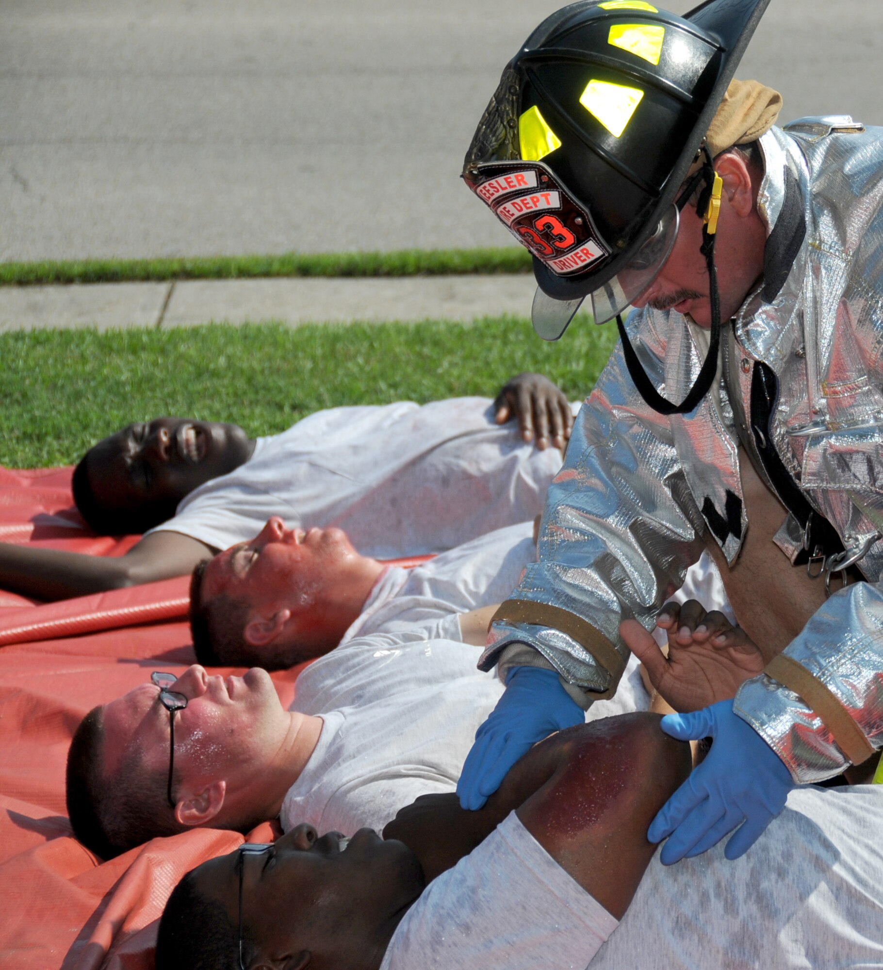 firefighter Guy Chadwick evaluates the “injuries” of Airman Basic Brian Hines, a student in the 336th TRS.  (U.S. Air Force photo by Kemberly Groue)