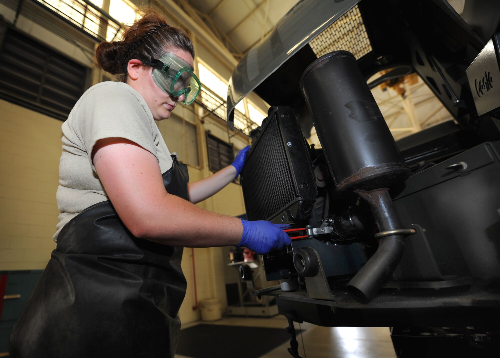 Airman 1st Class Mae Roles changes an oil filter on a self propelled servicing platform during a routine inspection on Joint Base Charleston, S.C., Sept. 2, 2010. The SPSP is a lift used to assist maintainers when trying to repair or inspect parts of the plane that are high off the ground. Airman Roles is an aerospace ground equipment apprentice with the 437 AGE. (U.S. Air Force Photo/Airman 1st Class Lauren Main)