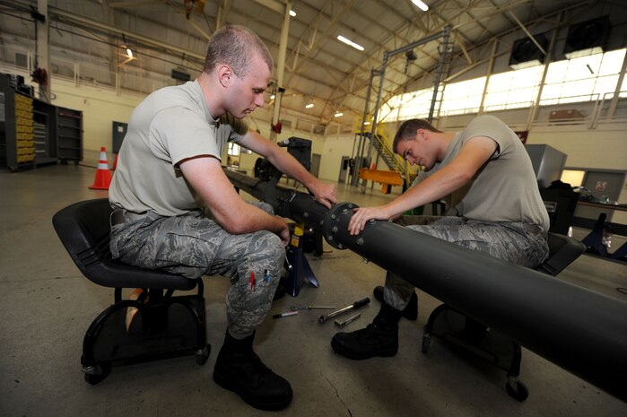 Senior Airman Alexander Ewing and Staff Sgt. Matthew Adelman inspect an universal aircraft tow bar for elongation and metal distortion during a bi-annual inspection on Joint Base Charleston, S.C., Sept. 2, 2010. The tow bar is used to tow almost all different types of transient aircraft that land at JB CHS around the flight line. Airman Ewing and Sergeant Adelman are aerospace ground equipment journeyman with the 437 AGE. (U.S. Air Force Photo/Airman 1st Class Lauren Main)