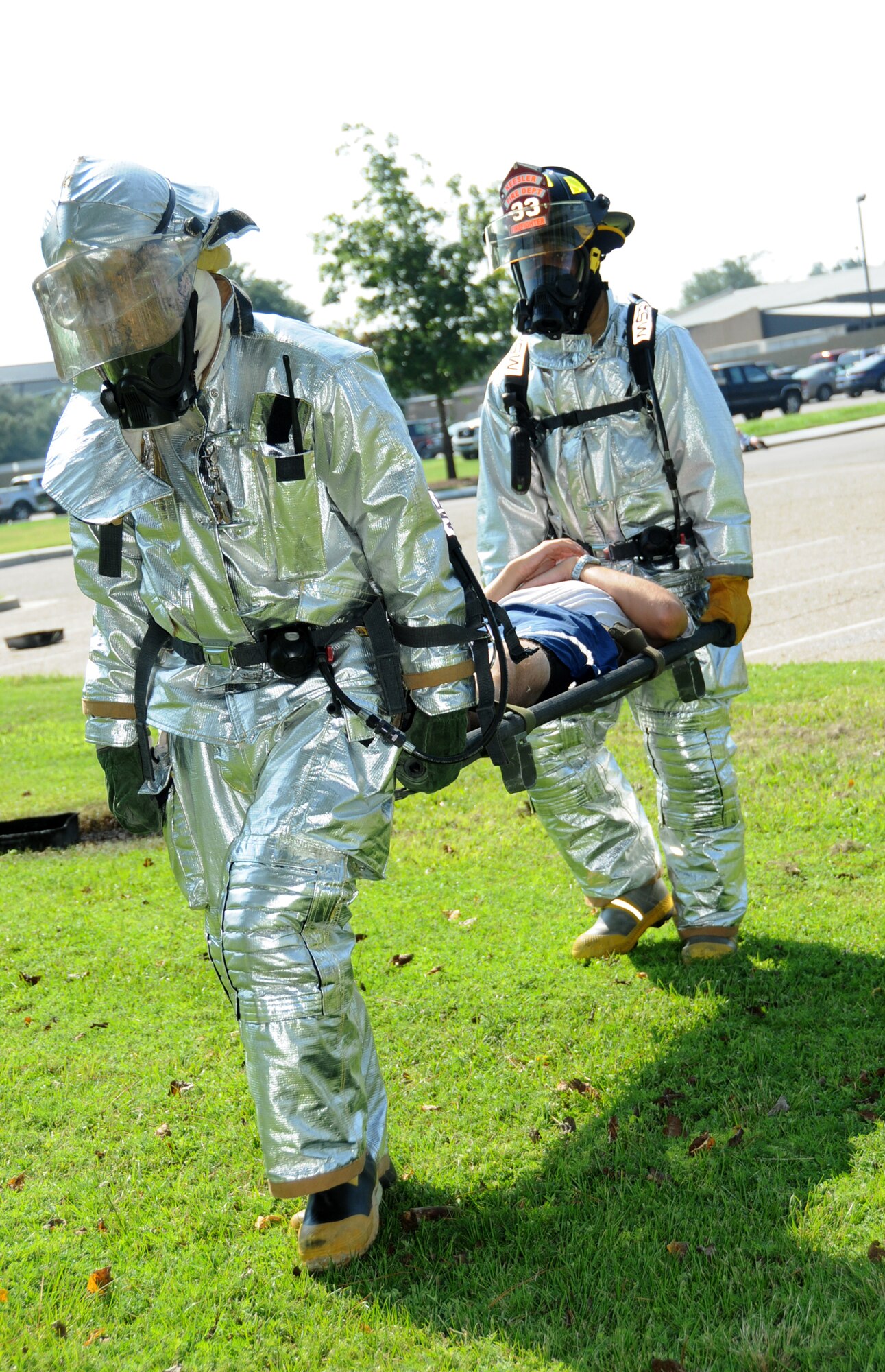 Sergeant Hobbs, left, and fellow firefighter Airman 1st Class Jeffery Spivey carry a “burn victim,” Airman Basic Justin Acord, to the triage area. Airman Acord is a student in the 338th Training Squadron.  (U.S. Air Force photo by Kemberly Groue)