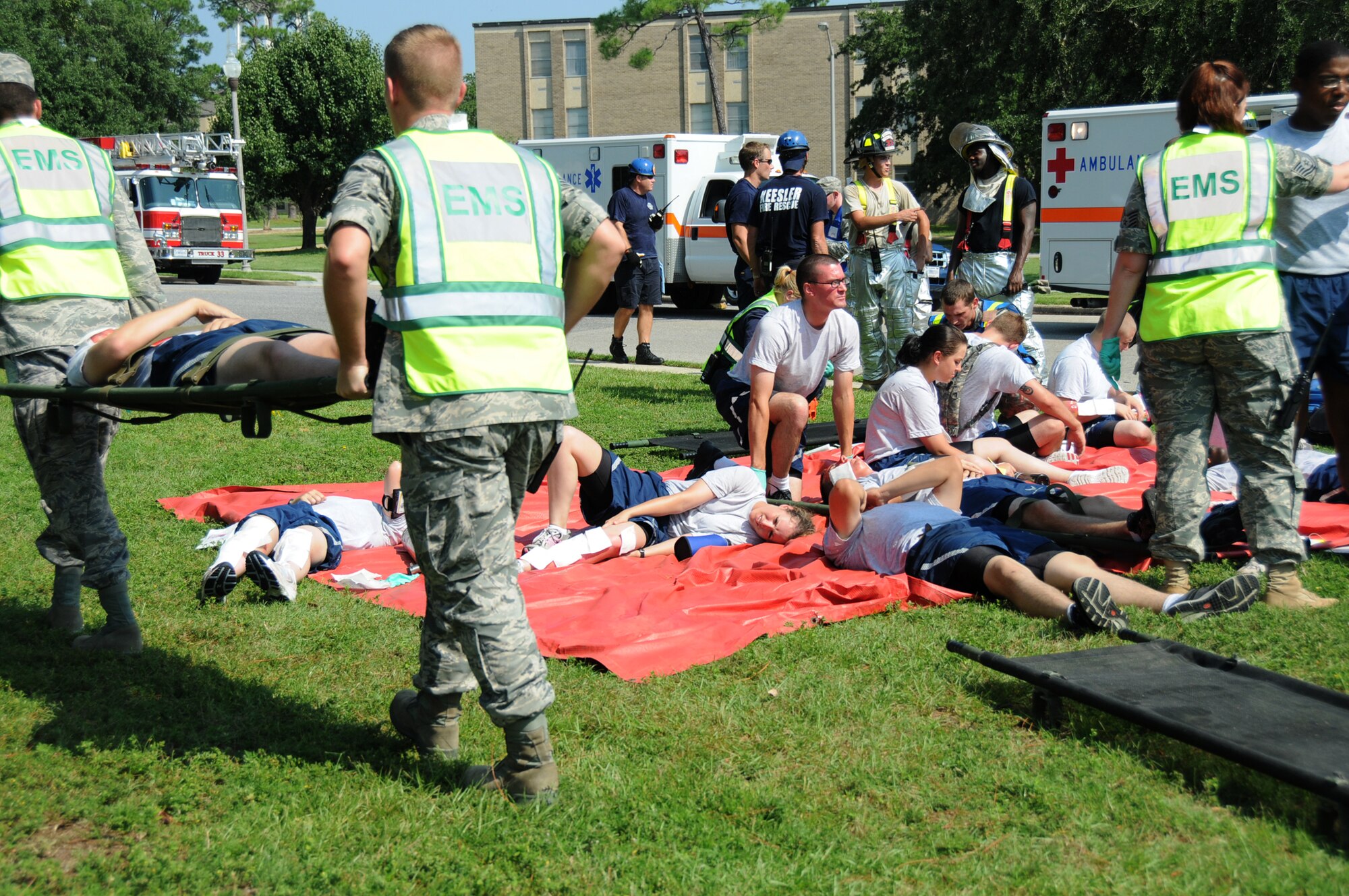 A triage area is established behind the supply warehouse for an Aug. 25 major accident response exercise. In the scenario, a leaking fuel truck caught on fire, resulting in injuries to the truck driver and 20 nonprior service students.  (U.S. Air Force photo by Kemberly Groue)