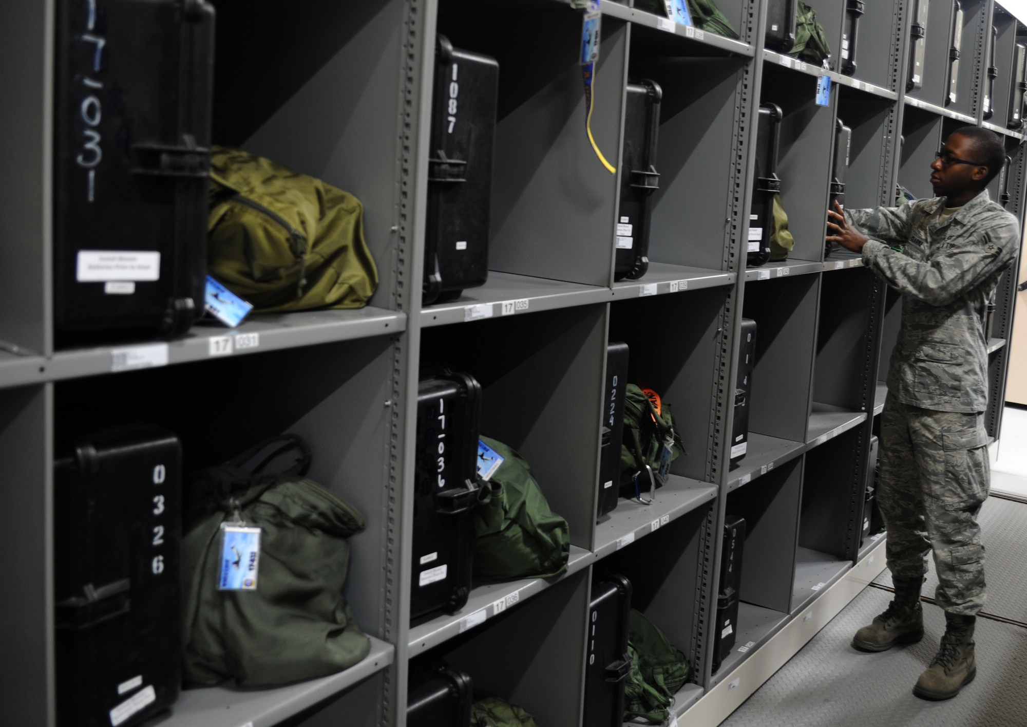 U.S. Air Force Airman 1st Class Daniel Clarke places an aircrew member's chemical warfare flight suit into his respective locker after inspection Sept. 1, 2010, on Joint Base Charleston, S.C. The aircrew flight equipment shop houses more than 1,400 individual lockers for aircrew members from the 1st Combat Camera Squadron to the 628th Logistics Readiness Squadron. Aircrew chemical gear is inspected every 18 months to ensure materials and devices still maintain safe functionality. Airman Clarke is an aircrew flight equipment technician with the 437th Operations Support Squadron. (U.S. Air Force photo/Senior Airman Timothy Taylor)
