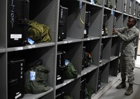 U.S. Air Force Airman 1st Class Daniel Clarke places an aircrew member's chemical warfare flight suit into his respective locker after inspection Sept. 1, 2010, on Joint Base Charleston, S.C. The aircrew flight equipment shop houses more than 1,400 individual lockers for aircrew members from the 1st Combat Camera Squadron to the 628th Logistics Readiness Squadron. Aircrew chemical gear is inspected every 18 months to ensure materials and devices still maintain safe functionality. Airman Clarke is an aircrew flight equipment technician with the 437th Operations Support Squadron. (U.S. Air Force photo/Senior Airman Timothy Taylor)