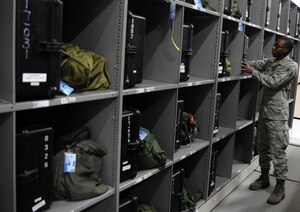 U.S. Air Force Airman 1st Class Daniel Clarke places an aircrew member's chemical warfare flight suit into his respective locker after inspection Sept. 1, 2010, on Joint Base Charleston, S.C. The aircrew flight equipment shop houses more than 1,400 individual lockers for aircrew members from the 1st Combat Camera Squadron to the 628th Logistics Readiness Squadron. Aircrew chemical gear is inspected every 18 months to ensure materials and devices still maintain safe functionality. Airman Clarke is an aircrew flight equipment technician with the 437th Operations Support Squadron. (U.S. Air Force photo/Senior Airman Timothy Taylor)
