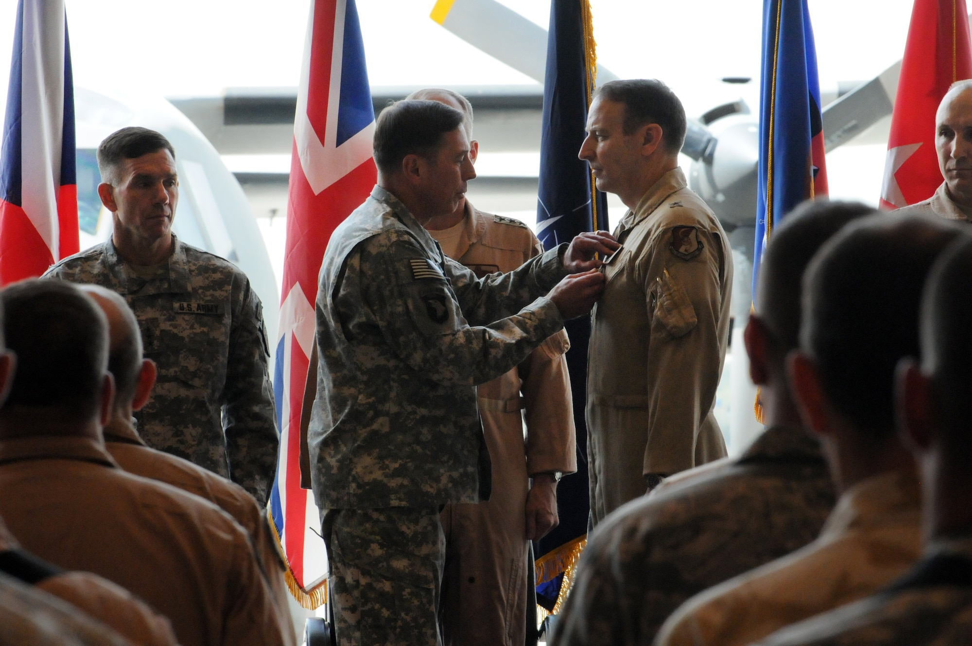 100907-N-6031Q-009 KABUL, Afghanistan -Gen. David Petraeus, Commander, International Security Assistance Force, Commander U.S. Forces Afghanistan, center-left, presents Brig. Gen. Michael Boera, Commanding General Combined Air Power Transition Force, the Defense Superior Service Medal as Lt. Gen. William B. Caldwell, Commanding General, NATO Training Mission and Combined Security Transition Command - Afghanistan, left, Lt. Gen. Gilmary Hostage, Commander, U.S. Air Forces, Central Command, Southwest Asia, and Brig. Gen. David W. Allvin, Commanding General, 438th Air Expeditionary Wing, NATO Air Training Command- Afghanistan, watch during the change of command ceremony between Boera and Allvin held on the Afghan Air Force base in Kabul, Afghanistan on Sep. 7, 2010. The change of command from Boera to Allvin marks the end of CAPTF and the beginning of the newly name NATC-A.(US Navy photo by Mass Communication Specialist 2nd Class David Quillen/ RELEASED).