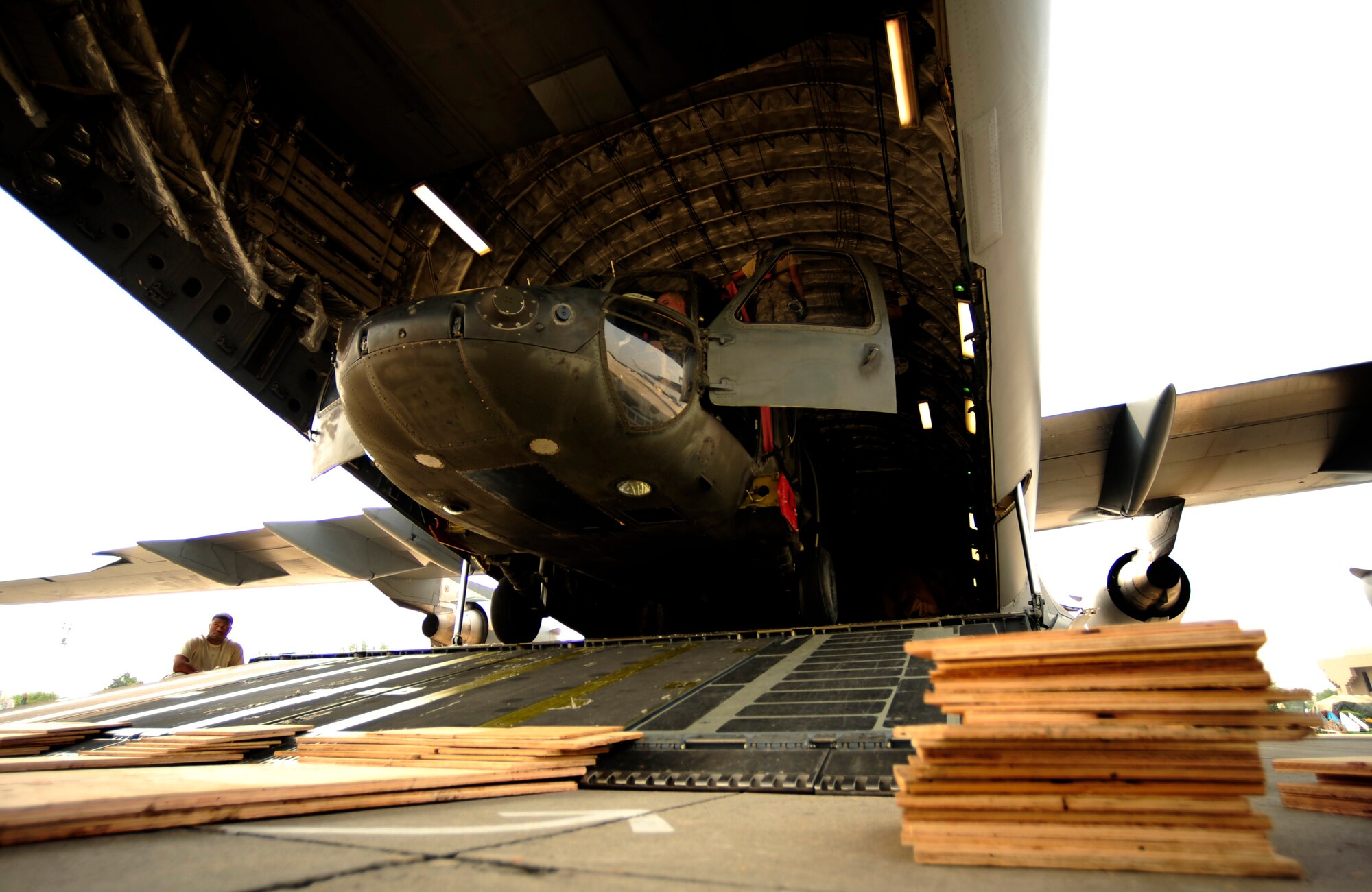 U.S. Air Force airmen from the 818th Contingency Response Element and U.S. Army soldiers from the 16th Combat Aviation Brigade take the straps off of UH-60 Blackhawk helicopters and cargo aboard a C-17 Globemaster III aircraft at Chaklala Air Force Base, Pakistan on Sept. 1, 2010. The 16th CAB just arrived in Pakistan and is going to air transport supplies throughout the country.

(U.S. Air Force photo by Staff Sgt. Andy M. Kin / Released)