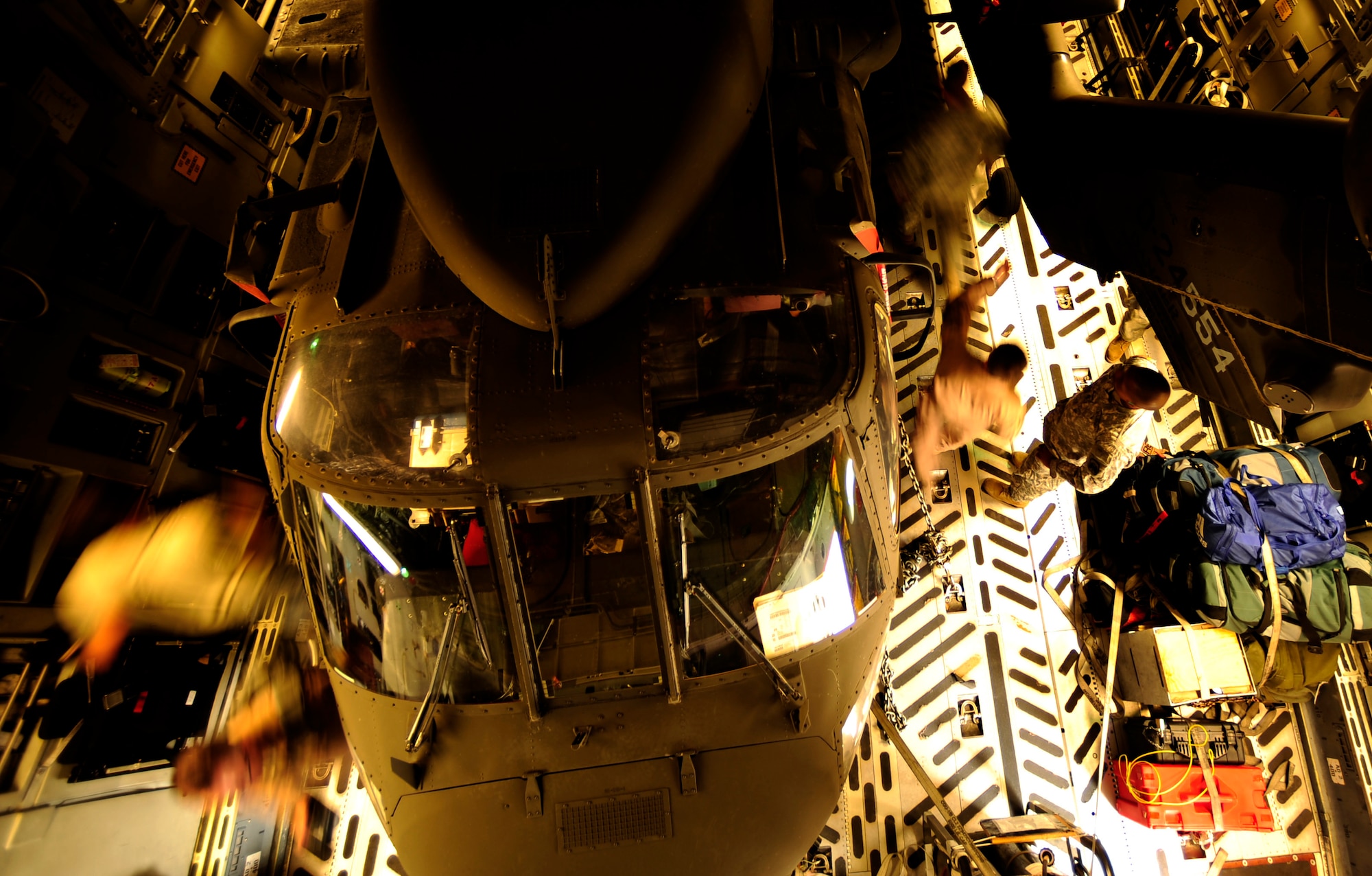U.S. Air Force airmen from the 818th Contingency Response Element and U.S. Army soldiers from the 16th Combat Aviation Brigade take the straps off a UH-60 Blackhawk helicopter aboard a C-17 Globemaster III aircraft at Chaklala Air Force Base, Pakistan on Sept. 1, 2010. The 16th CAB just arrived in Pakistan and is going to air transport supplies throughout the country.

(U.S. Air Force photo by Staff Sgt. Andy M. Kin / Released)