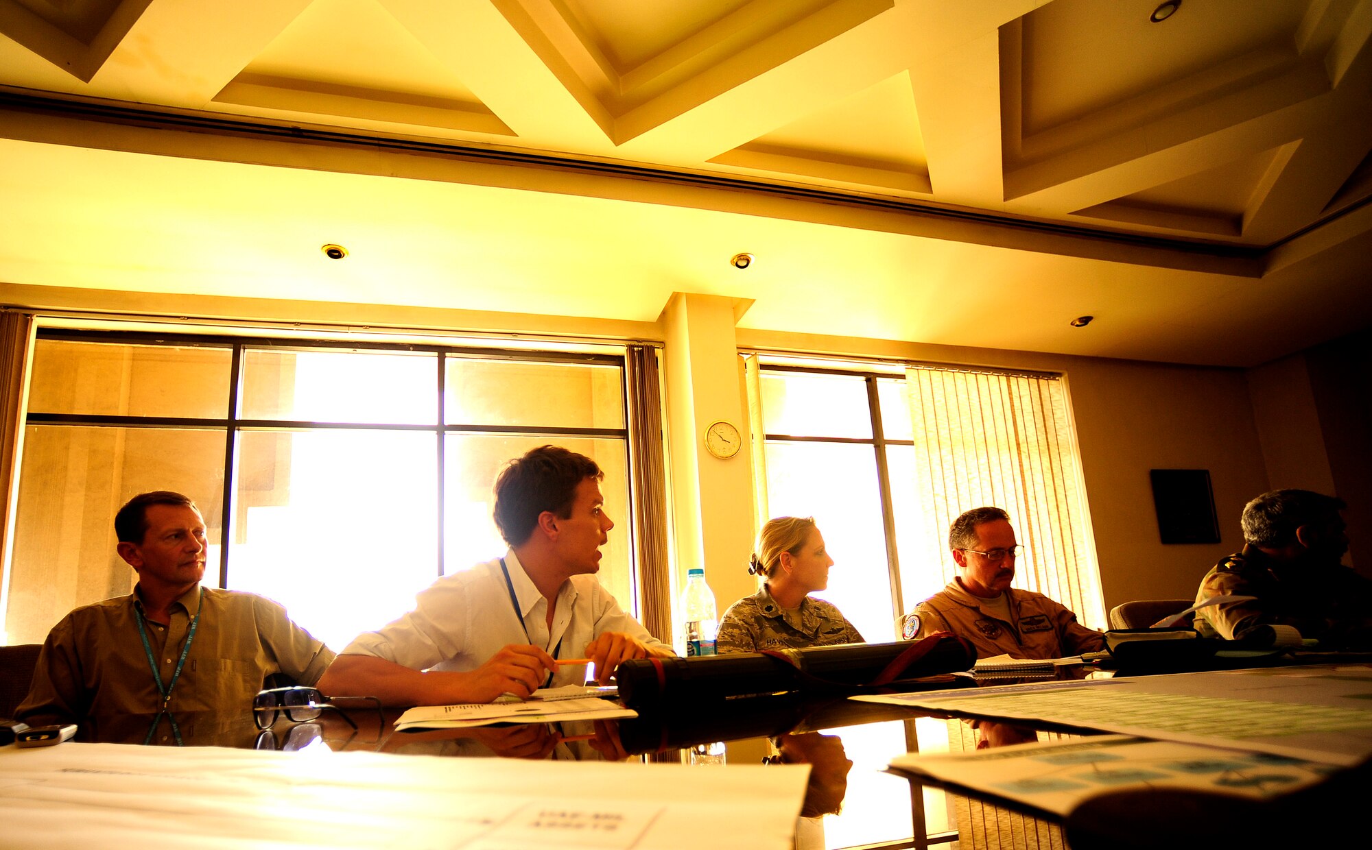 Simon Hacker, senior UN Logistics Cluster coordinator (center), discusses numbers and locations with Pakistan Maj. Gen Arif, commander of the Army Aviation Command, during an Air Coordination Cell meeting with many U.S., Pakistan, and international organizations aimed at flood relief efforts in Pakistan. The ACC was formed to discuss available food and supply requirements needed in flooded areas throughout Pakistan and means for transporting items all throughout the country.(U.S. photo taken by Staff Sgt. Andy M. Kin)