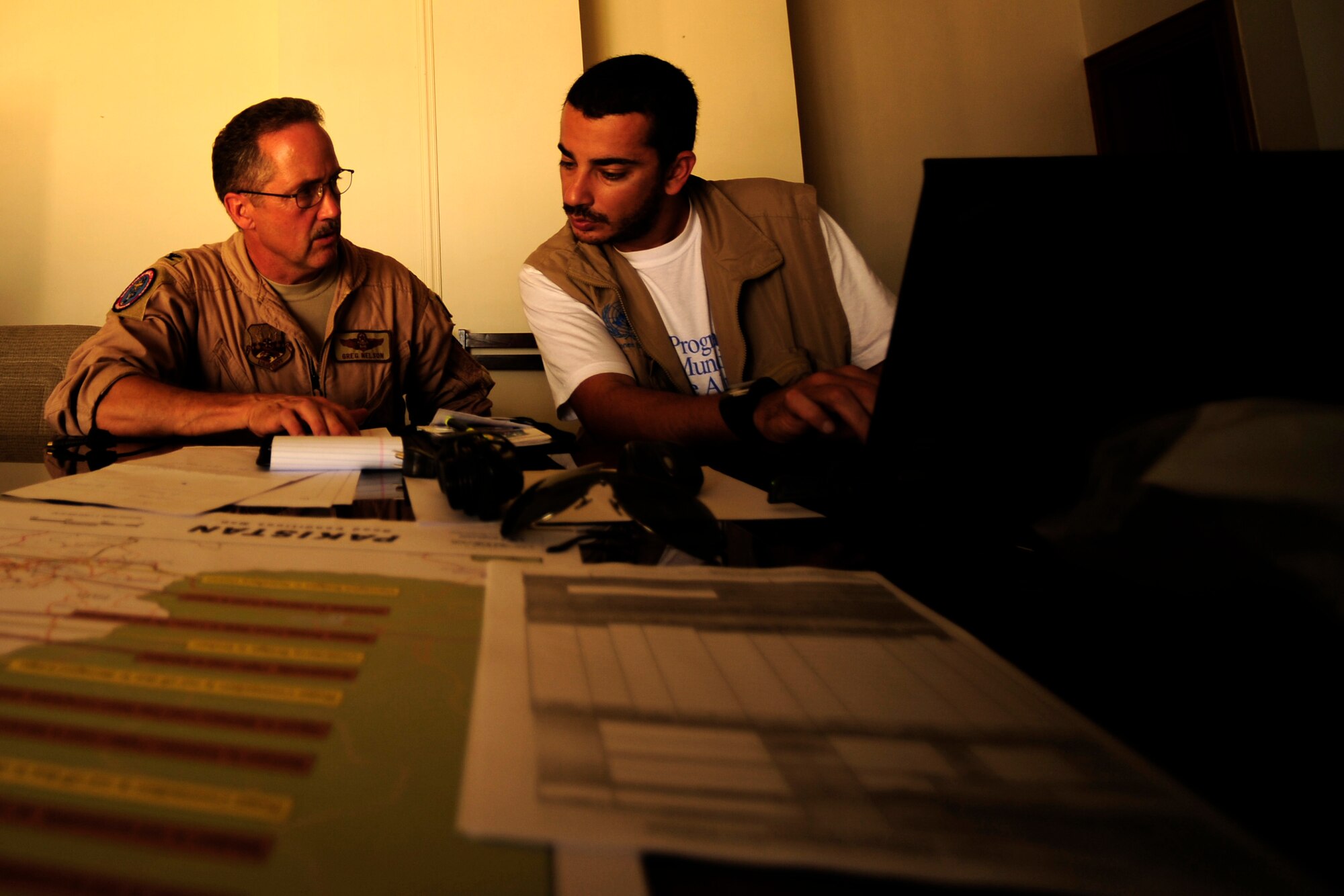 U.S. Air Force Col. Greg Nelson, Director of Mobility Forces for Humanitarian Assistance to Pakistan(left) and a member of the World Food Program go over flight schedule for the next week on supplies being transported all over Pakistan in support of flood relief efforts on Aug. 28, 2010. An Air Coordination Cell was formed to discuss available food and supply requirements needed in flooded areas throughout Pakistan and means for transporting items all over country.

(U.S. photo taken by Staff Sgt. Andy M. Kin)