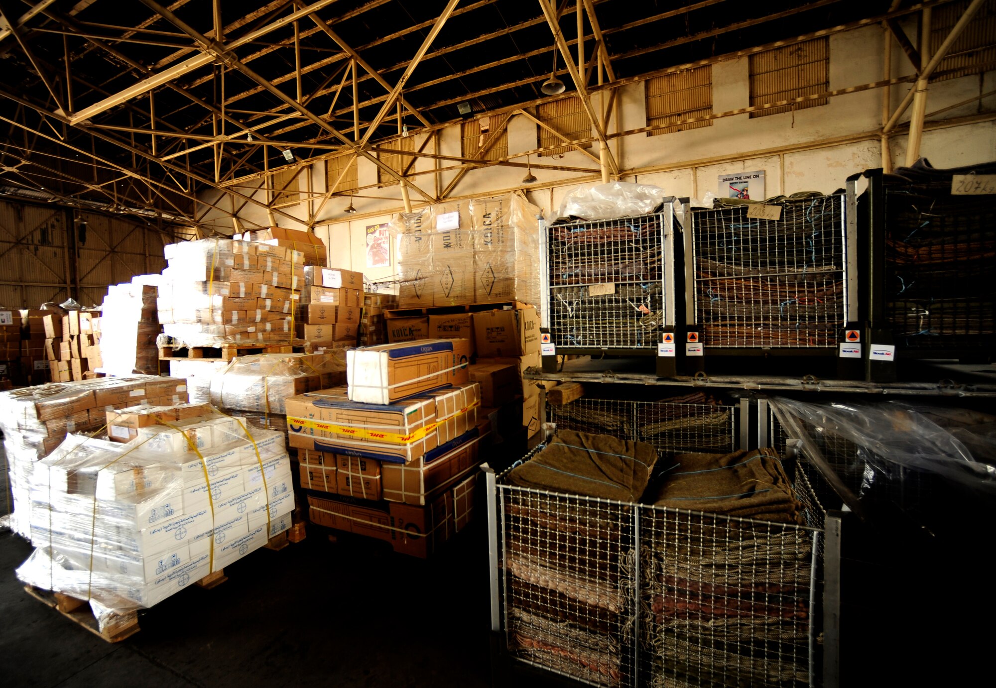 Tons of food and equipment fill a hangar at Chaklala Air Field, Pakistan in support of flood relief efforts on Aug. 28, 2010.   A U.S. Air Force Contingency Response Team from the 88th McGuire Air Force Base, NJ arrived today, taking over responsibilities for loading and off loading U.S. aircraft with supplies all over Pakistan. 

(U.S. photo taken by Staff Sgt. Andy M. Kin)