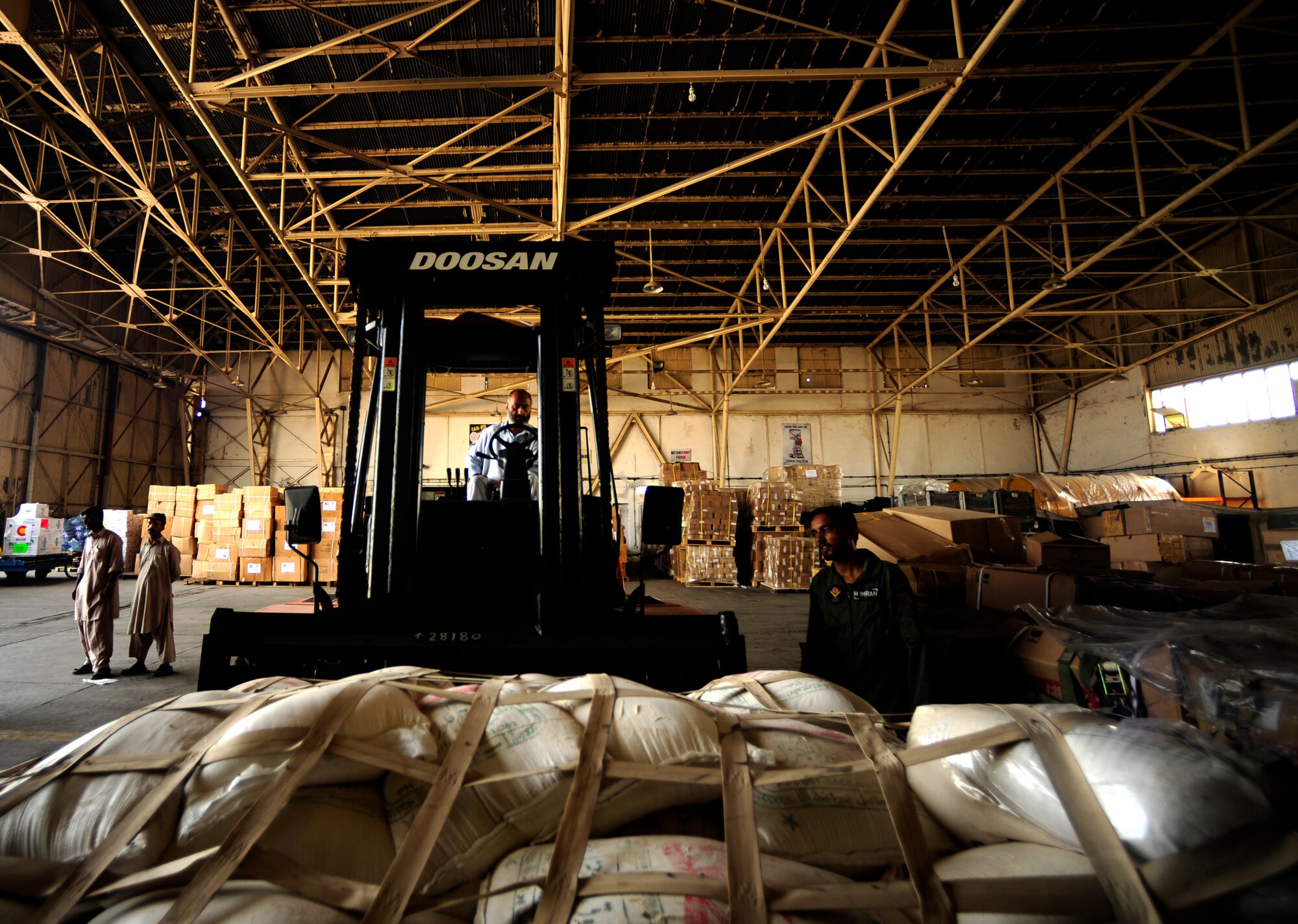 A local Pakistani man operates a forklift, moving pallets of food out of the hangar to a designated spot for air transport at Chaklala Air Field, Pakistan in support of flood relief efforts on Aug. 28, 2010.  A U.S. Air Force Contingency Response Team from the 88th McGuire Air Force Base, NJ arrived today, taking over responsibilities for loading and off loading U.S. aircraft with supplies all over Pakistan. 

(U.S. photo taken by Staff Sgt. Andy M. Kin)