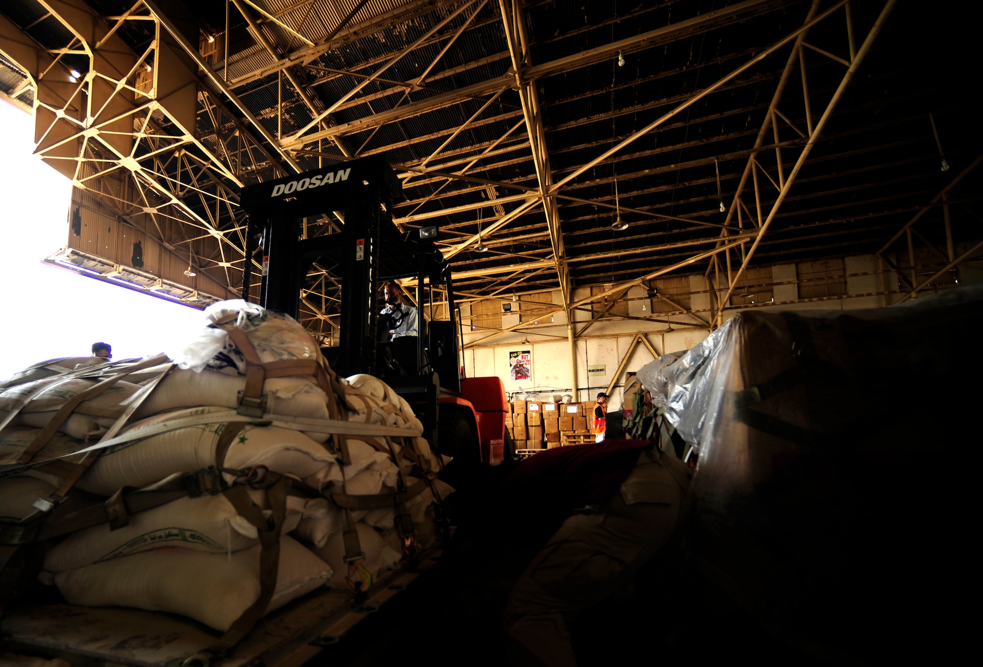 A local Pakistani man operates a forklift, moving pallets of food out of the hangar to a designated spot for air transport at Chaklala Air Field, Pakistan in support of flood relief efforts on Aug. 28, 2010.  A U.S. Air Force Contingency Response Team from the 88th McGuire Air Force Base, NJ arrived today, taking over responsibilities for loading and off loading U.S. aircraft with supplies all over Pakistan. 

(U.S. photo taken by Staff Sgt. Andy M. Kin)