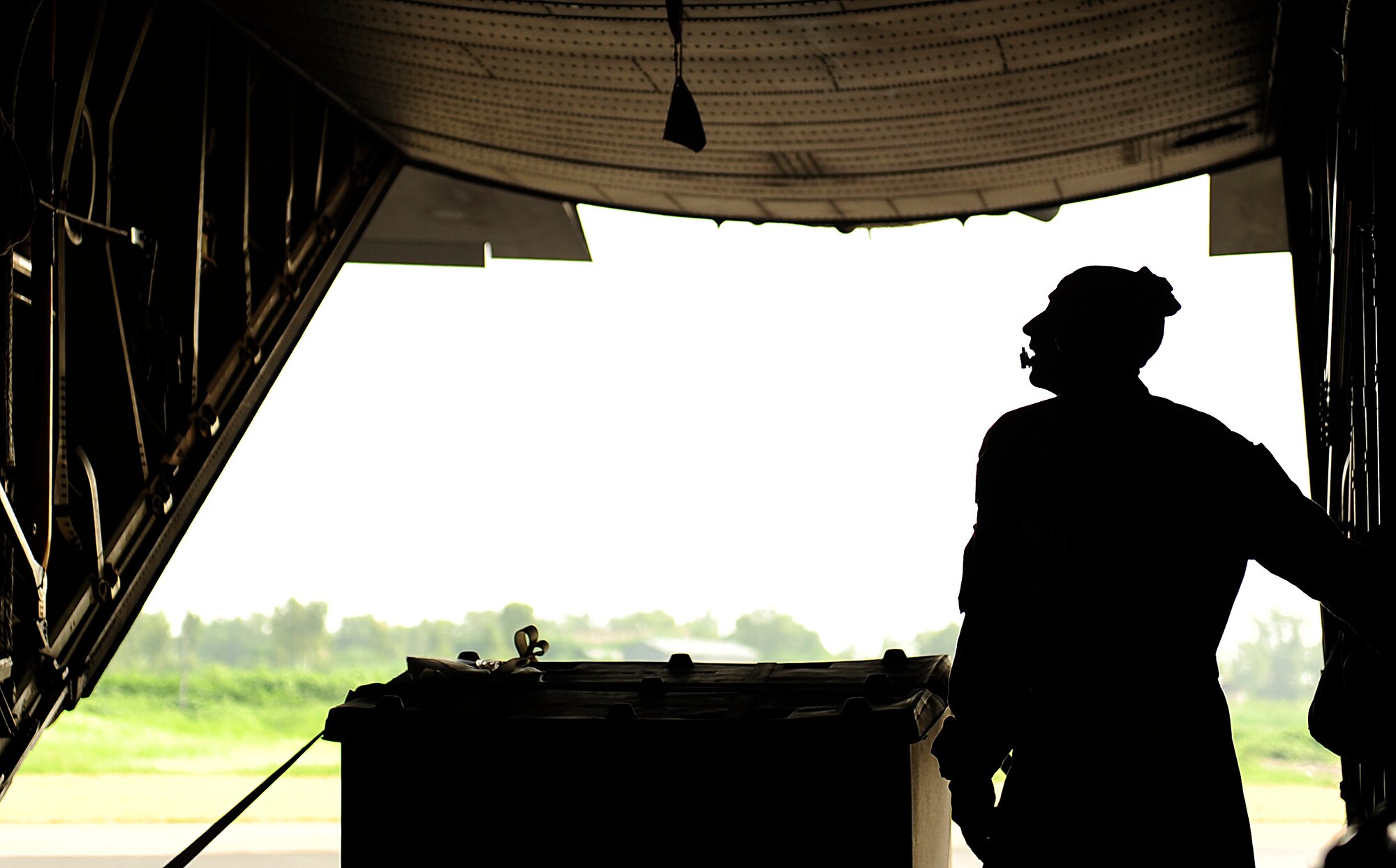 U.S. Air Force Tech Sgt. Adam Nixon a C-130H Hercules loadmaster assigned to  the 746th Expeditionary Airlift Squadron, stands on the open ramp waiting for forklifts to off load cargo at Chaklala Air Force Base, Pakistan in support of humanitarian relief efforts from Bagram Airfield, Afghanistan Aug 22, 2010. 
(U.S. Air Force photo by Staff Sgt. Andy M. Kin / Released)