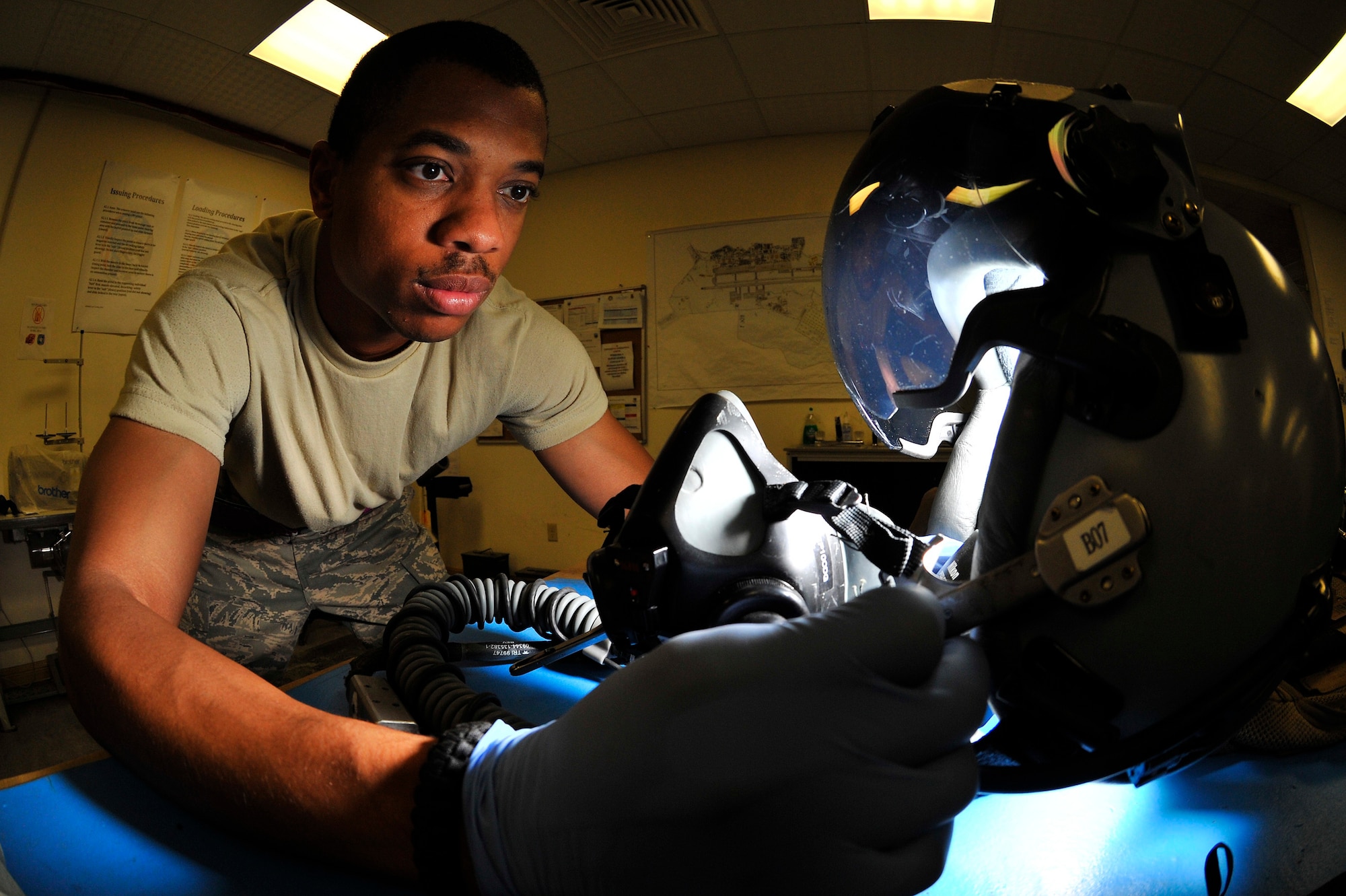 Staff Sgt. Courtney Martin, an aircrew flight equipment technician assigned to the 510th Expeditionary Fighter Squadron, performs a preflight inspection of a helmet at Bagram Airfield, Afghanistan, Sept. 2, 2010. Sergeant Martin is a native of Jackson, Tenn. (U.S. Air Force photo/Staff Sgt. Christopher Boitz)
