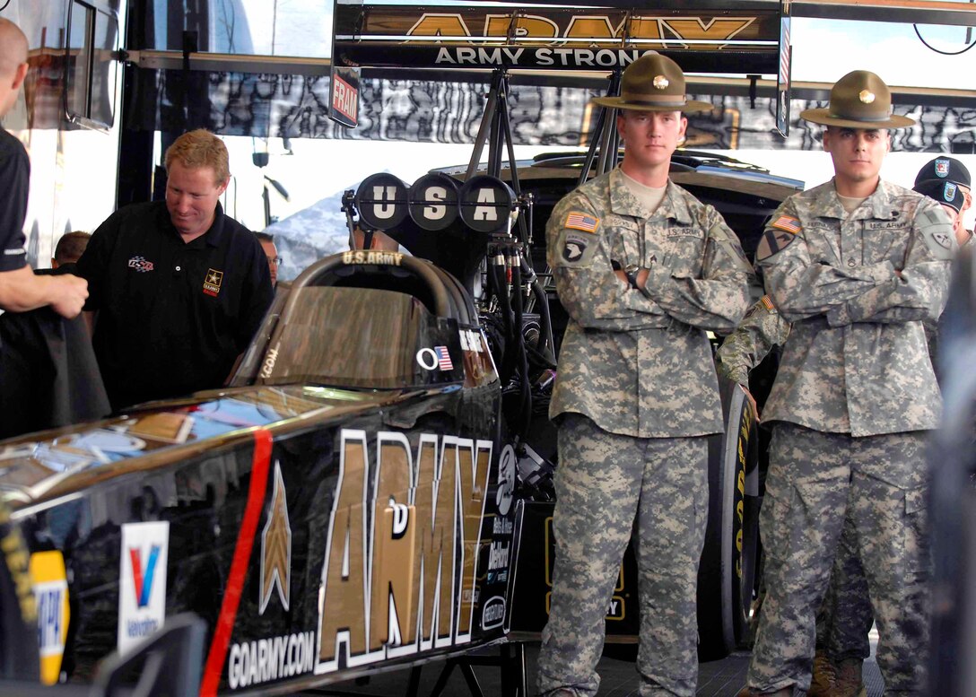 Fort Knox's Drill Sergeant of the Year Staff Sgt. Benjamin Brady and runner up Staff Sgt. Duarte Fernandes stand next to the Army's newest hot rod in Indianapolis, Sept. 3, 2010. Brady and Fernandes were recognized during unveiling ceremony for their achievements as drill sergeants.
