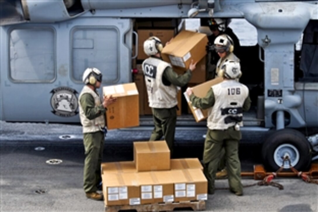 U.S. Marines load diaster relief supplies onto an MH-60S Seahawk helicopter aboard the amphibious assault ship USS Peleliu at sea, Sept. 6, 2010. The Peleliu is sending an initial supply of 80 pallets of relief supplies to Sharea Faisal Air Base, Pakistan, for further distribution to Pakistan's flooded regions. The Seahawk is assigned to Helicopter Sea Combat 23.