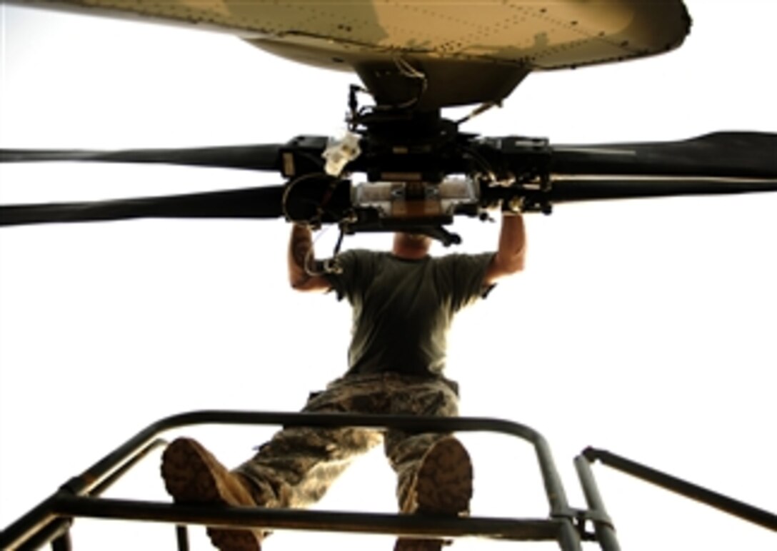 U.S. Army Staff Sgt. Jason Trammell, a UH-60 Black Hawk helicopter maintenance technician assigned to the 16th Combat Aviation Brigade, Fort Wainwright, Alaska, works on the rear rotor of a helicopter at Pakistan Air Force Base Chaklala, Pakistan, on Sept. 2, 2010.  The 16th Combat Aviation Brigade delivered flood relief supplies throughout the country.  