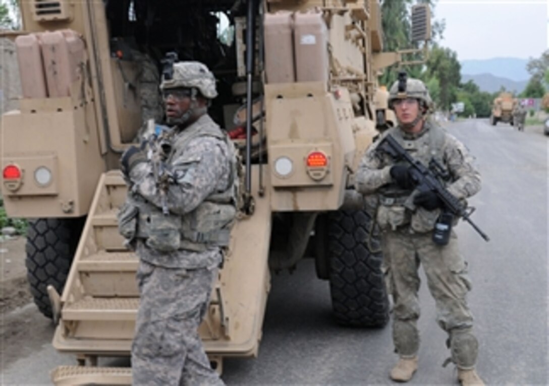 U.S. Army Cpl. Mark D. Jennings (left) and Spc. Ryan A. Quattlebaum, both team leaders with 1st Platoon, Baker Company, 2nd Battalion, 327th Infantry Regiment, provide security during a unit visit to Kutgay village, Kunar province, Afghanistan, on Aug. 25, 2010.  