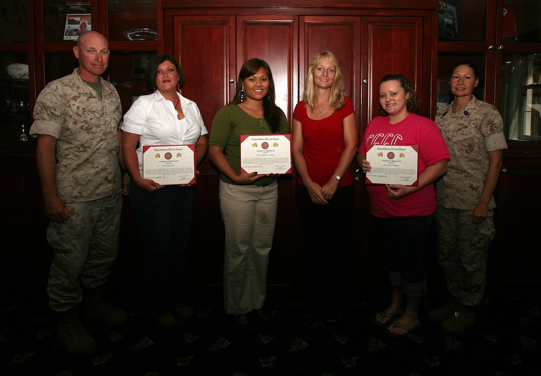 From left to right Maj. William Stophel, the commanding officer of Combat Logistics Battalion 6, 2nd Marine Logistics Group, poses with ‘Key Volunteers’ Tonya Dye, Lamphone Schueder, battalion family readiness officer Mary Mathews, Alysia Ohlinger and 1st Sgt. Raquel Painter, the battalion sergeant major for CLB-6, 2nd MLG, at the Commissioned Officers Club here, Sept. 8. The volunteers were presented with certificates of appreciation for the assistance provided to Mathews throughout the duration of the unit’s seven month deployment to Afghanistan. (U.S. Marine Corps photo by Sgt. Justin J. Shemanski)