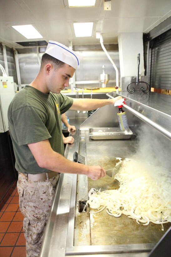 Lance Cpl. Eric W. Bailey, a food service specialist with Headquarters and Service Company, Battalion Team 3/8, 26th Marine Expeditionary Unit, prepares lunch in the galley aboard USS Kearsarge, Sept. 8, 2010. 26th Marine Expeditionary Unit deployed aboard the ships of Kearsarge Amphibious Ready Group in late August responding to an order by the Secretary of Defense to support Pakistan flood relief efforts.