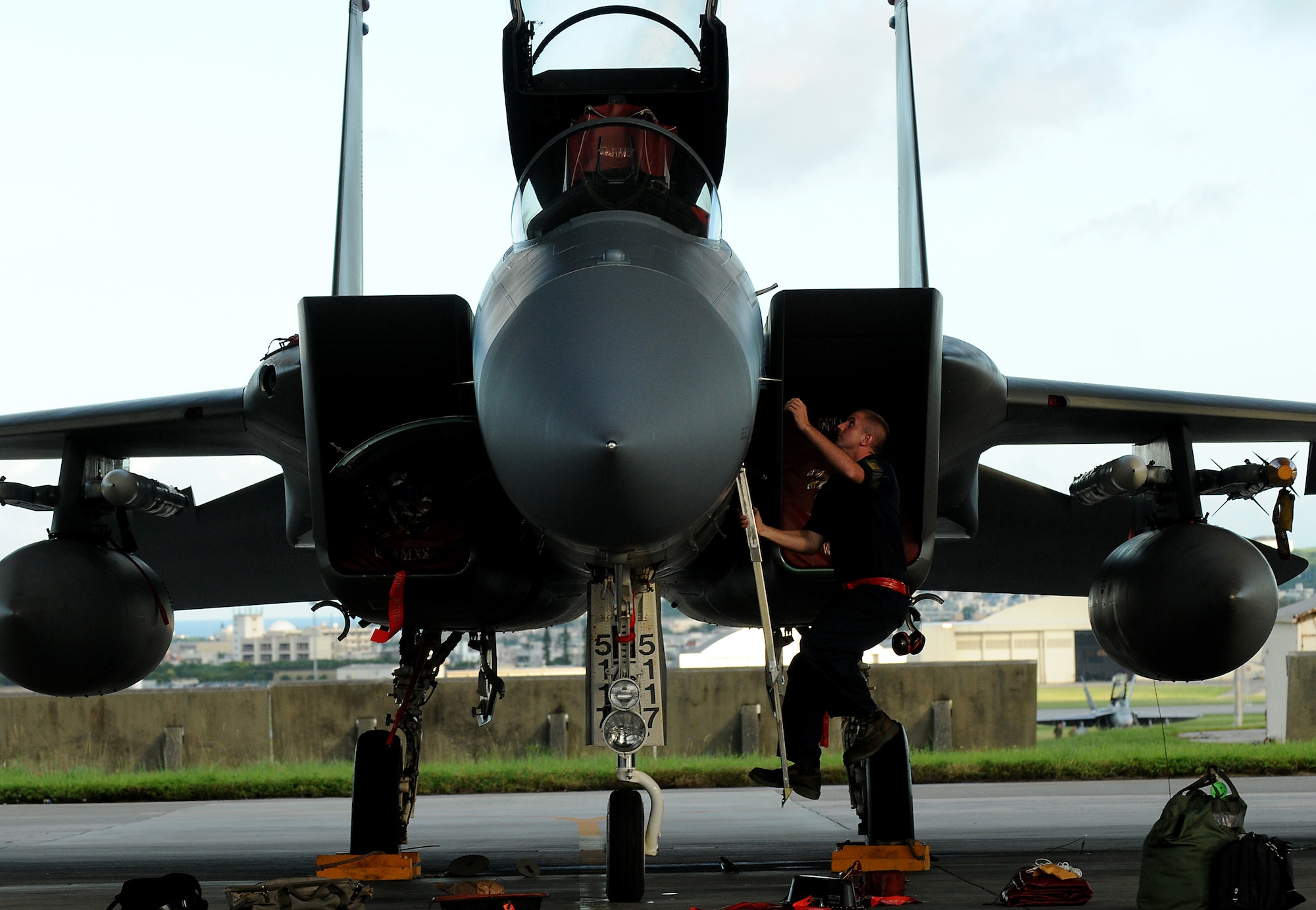 Airman 1st Class Evan Dugan, a crew chief with the 67th Aircraft Maintenance Unit, removes covers from an F-15, Sept. 8, before it departs for Valiant Shield, a joint training exercise held in Guam. More than 18 aircraft and 600 Kadena members are deploying in support of this bi-annual operation. (US Air Force photo/Staff Sgt. Christopher Hummel)