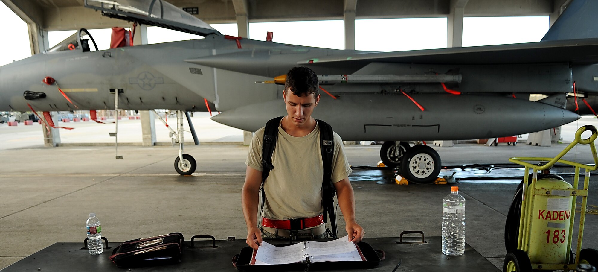 Airman Justen Schulz, an avionics apprentice with the 67th Aircraft Maintenance Unit inspects maintenance forms for an F-15 before it departs for Valiant Shield held in Guam, Sept. 8, 2010. More than 18 aircraft and 600 Kadena members deployed in support of the bi-annual operation. (US Air Force photo/Staff Sgt. Christopher Hummel)