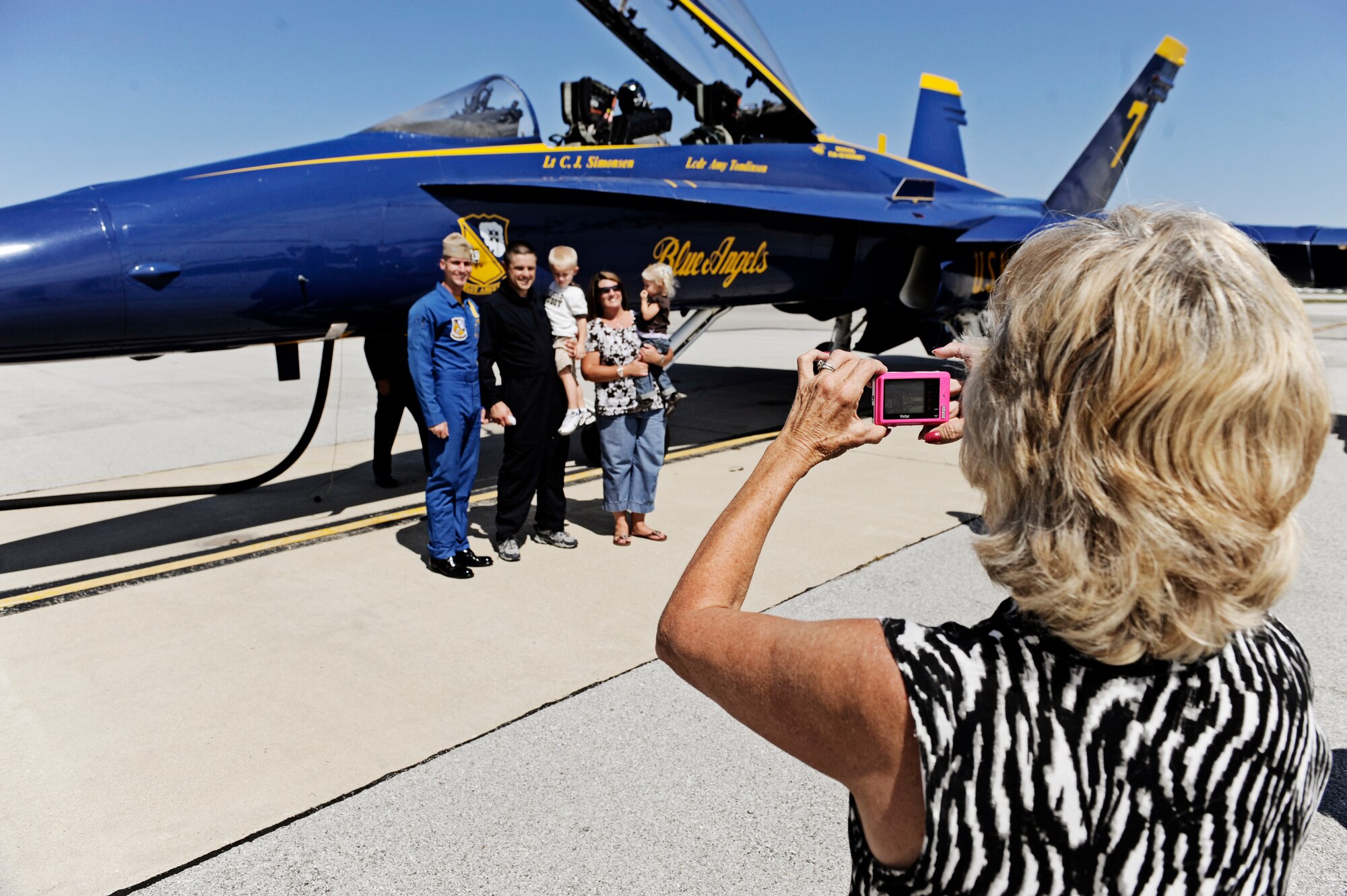 Farrell Shelton, high school history teacher and football coaach poses for pictures with his family Sept. 8 at Scott AFB. The U.S. Navy in conjunction with the Scott Air Force Base air show, Airpower Over the Midwest, took two community leaders and one member of the media on orientation flights in an F/A-18 Hornet around the greater Scott area to give them a taste of what it?s like to be a military fighter pilot. (U.S. Air Force photo/ Staff Sgt. Ryan Crane)