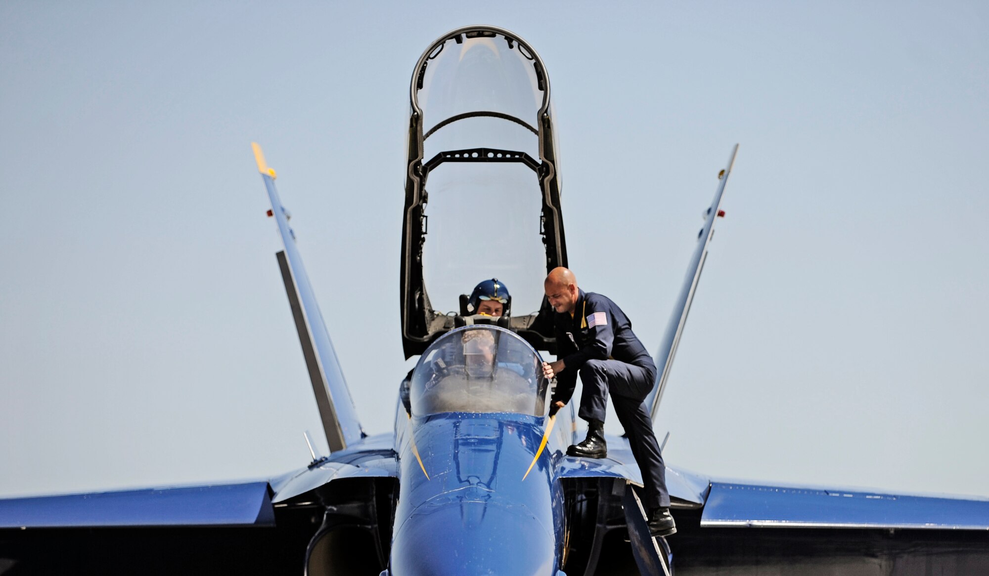 Petty Officer Chad Swanson, Blue Angels #7 crew chief, instructs Farrell Shelton, high school history teacher and football coach how to control the volume in his headset Sept. 8 at Scott AFB. The U.S. Navy in conjunction with the Scott Air Force Base air show, Airpower Over the Midwest, took two community leaders and one member of the media on orientation flights in an F/A-18 Hornet around the greater Scott area to give them a taste of what it?s like to be a military fighter pilot. (U.S. Air Force photo/ Staff Sgt. Ryan Crane)