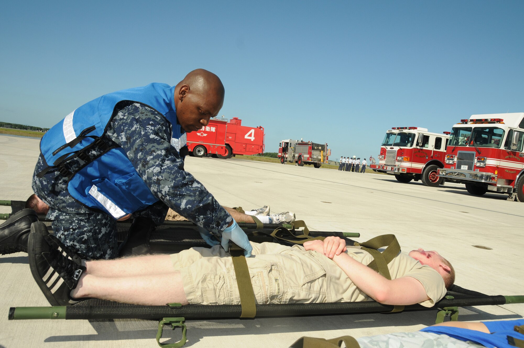 MISAWA AIR BASE, Japan - Hospital Navy Corpsman 2nd Class Chamunorwa Chimhau prepares a mock-accident casualty for transport during a Major Accident Response Exercise at Misawa Air Base, Sept. 8, 2010. This joint/bi-lateral exercise with the Navy, Air Force and Japanese Air Self-Defense Force is designed to improve interoperability in the event of a major catastrophe. (U.S. Navy photo by Mass Communication Specialist 2nd Class Matthew M. Bradley) (Released)