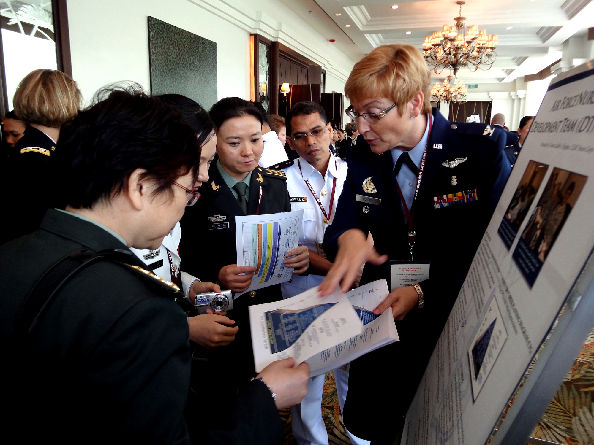 Col. Judith Hughes, the Pacific Air Forces’ chief nurse at Joint Base Pearl Harbor-Hickam Hawaii, talks to delegates from China and Indonesia during the 4th annual Asia-Pacific Nursing Conference Symposium where more than 200 nurses from 13 countries were in attendance.  The seven-day conference, hosted by the Armed Forces of the Philippines Office of the Chief Nurse, in collaboration with U.S. Pacific Command and 13th Air Force, focused on nursing education, career development, global pandemic preparedness and disaster management. The symposium was designed to help nurses in senior leadership positions share ideas and practices in order to build relations between Asia-Pacific countries.  The symposium concluded Sep. 4, 2010. (U.S. Air Force photo/ Tech. Sgt. Carlos Limo) 