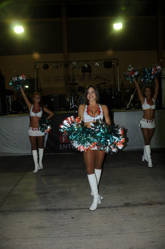 SOTO CANO AIR BASE, Honduras --  Performing a dance routine, the Miami Dolphins cheerleaders entertain Team Bravo during an Armed Forces Entertainment-hosted show here Sept. 2. The cheerleaders performed dance numbers and gave out prizes to audience members after their performance. (U.S. Army photo/Spc. Jennifer Grier)