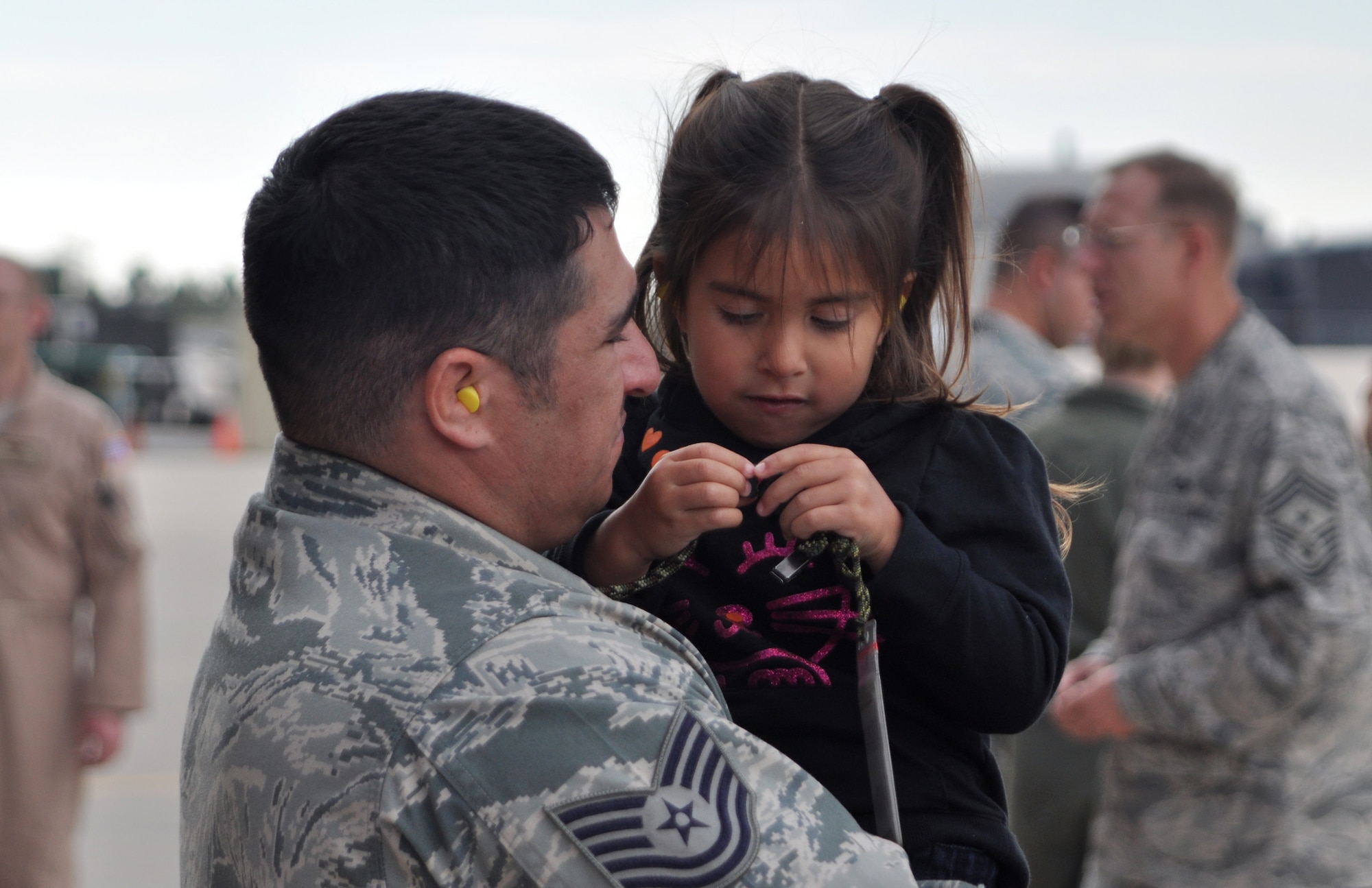 Air Force Reserve Tech. Sgt. Jamie Romero holds his daughter Aiyana tight before deploying to the Middle East Sept. 8 at Peterson Air Force Base, Colo. Sergeant Romero, assigned to the 302nd Maintenance Squadron, deployed with approximately 50 other Air Force Reservists in support of U.S. Central Command operations. More than 150 aircrew, maintenance and support AF Reservists from the 302nd AW will take part in this airlift support deployment package. The 302nd AW is an AF Reserve unit based at this southern Colorado installation. (U.S. Air Force photo/Staff Sgt. Stephen J. Collier)