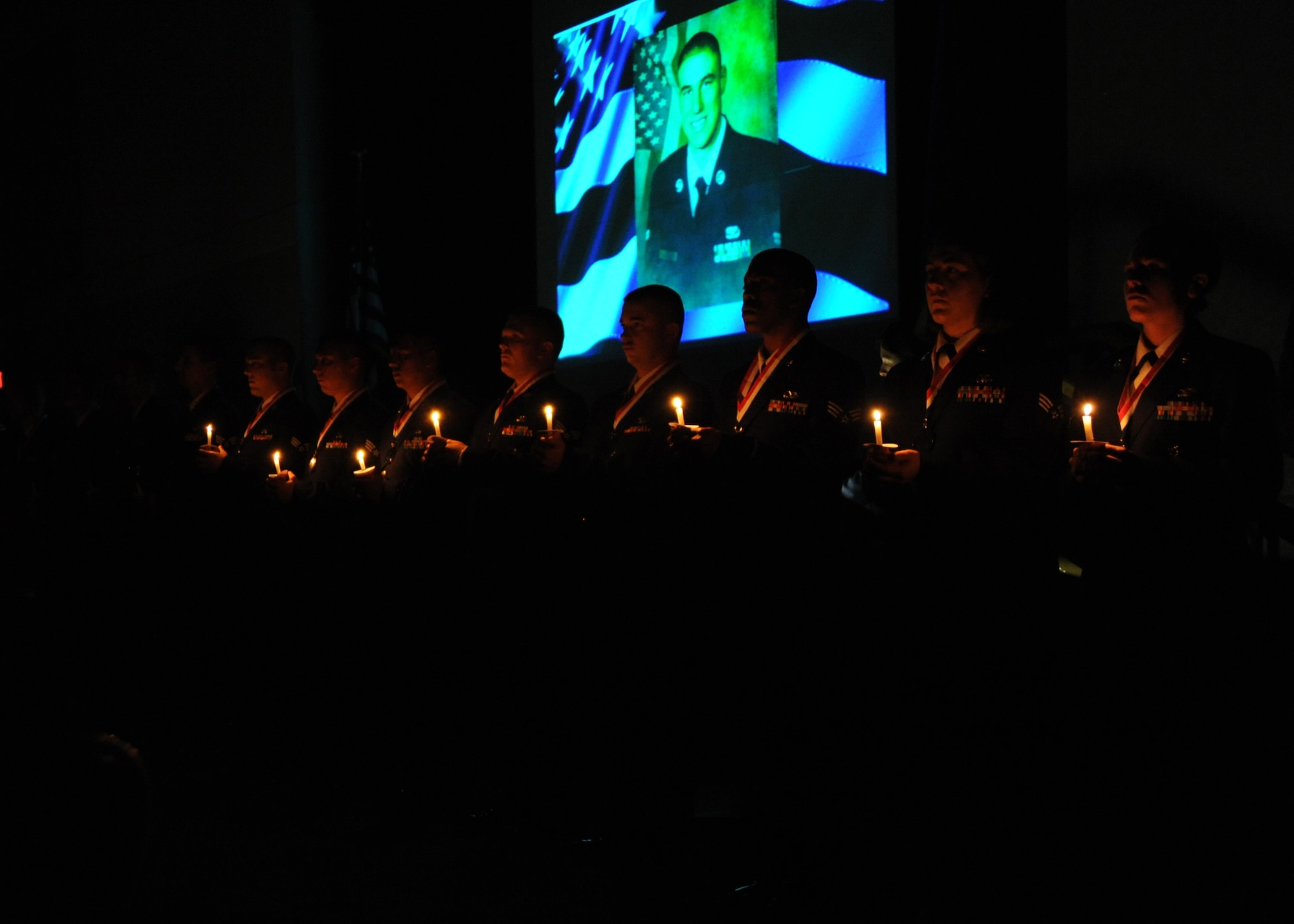 McConnell’s Airman Leadership School graduates of class 10-F light candles as a tribute to the victims of 9/11 during a graduation ceremony at the Robert J. Dole Community Center ballroom, Sept. 2, 2010, McConnell Air Force Base, Kan.  McConnell Airmen will also honor the victims of 9/11 at a Retreat Ceremony scheduled for 4:30 p.m. Sept. 10.  (U.S. Air Force photo/Airman 1st Class Andrea Salazar)