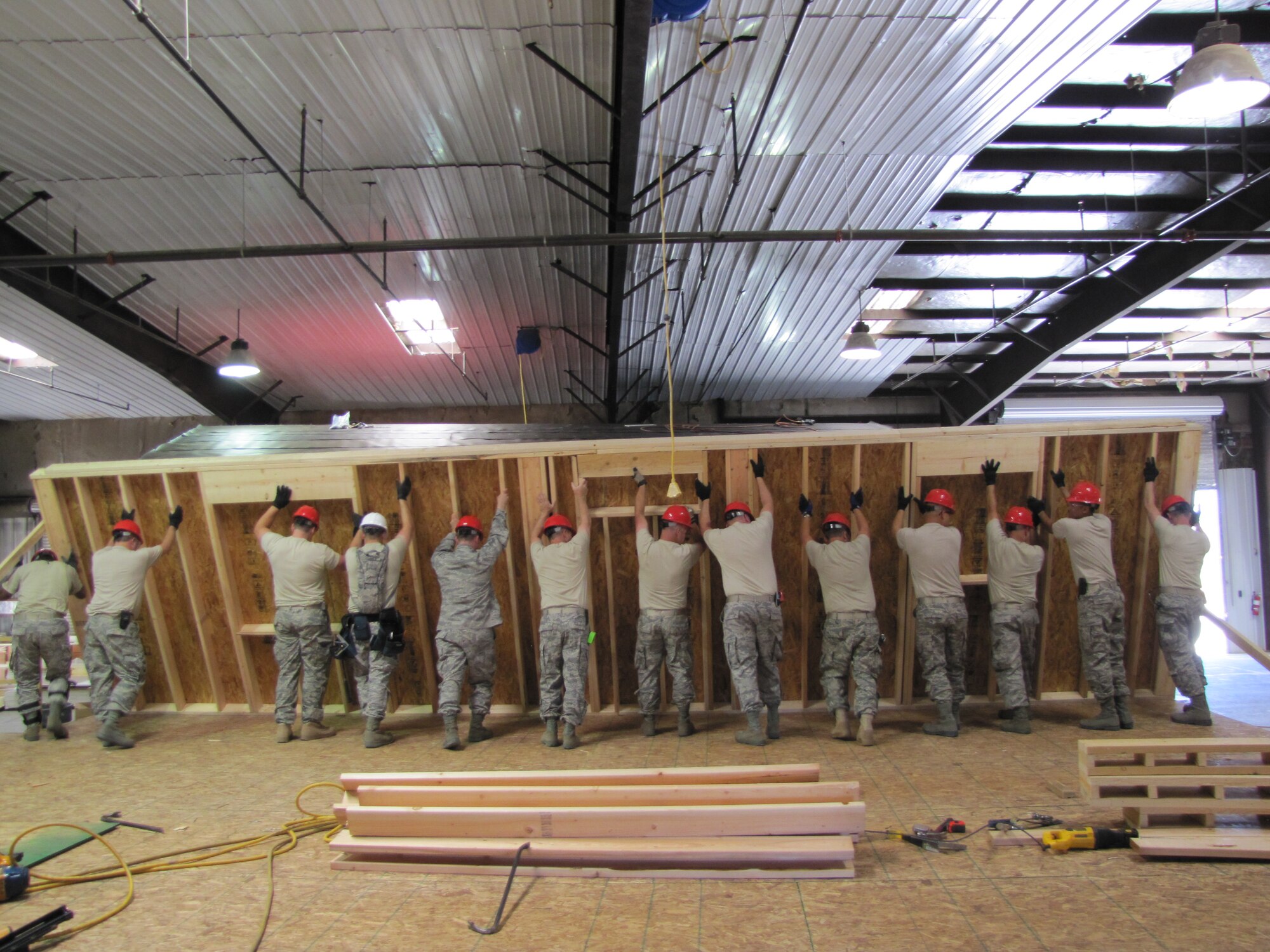 Airmen from the 560th Rapid Engineer Deployable Heavy Operational Repair Squadron Enginneers work together to build houses from the ground up in Gallup, New Mexico.  The 560 REDHORSE squadron spent three months aiding the Southwest Indian Foundation building houses for disadvantaged families.  This mission provides the 560th with the necessary training needed for deployments. (Courtesy photo)
