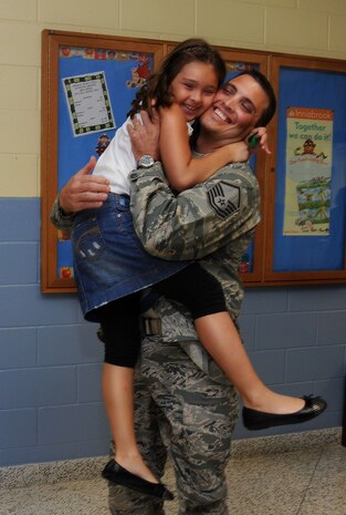 Master Sgt. Jamey Elms and his daughter, Audrey share a joyful, surprise reunion at her school upon Sergeant Elms' return from a four month deployment overseas Sept. 8, 2010. Audrey was on her way to lunch when she spotted her dad just around the corner. After the momentary shock wore off, she flung herself into his arms for a tearful reunion. This was Sergeant Elms' first deployment away from his family but he said the use modern communication eased the separation. Sergeant Elms is a crew chief with the 437th Maintenance Squadron. (U.S. Air Force Photo/Airman 1st Class Lauren Main)